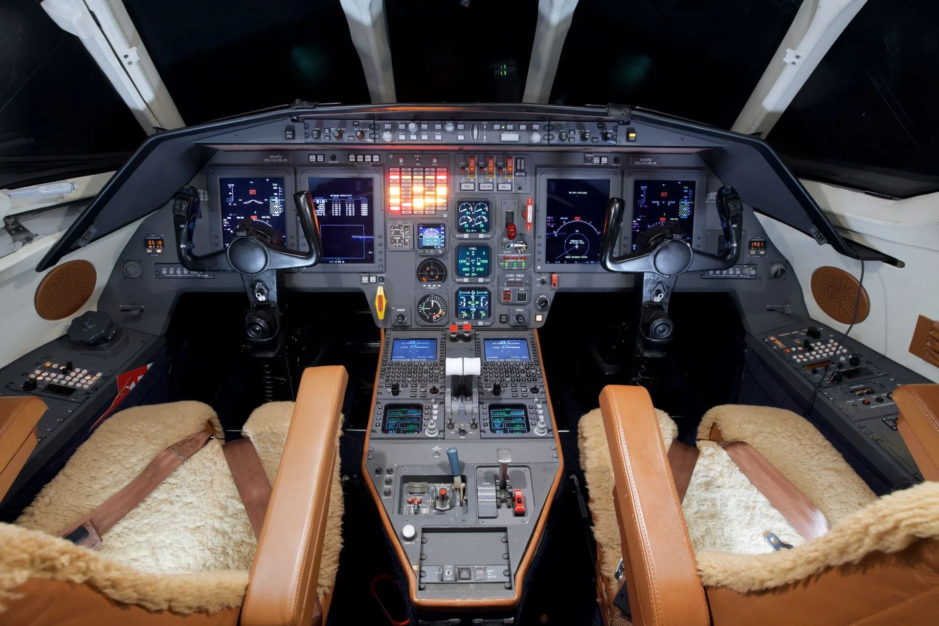 The cockpit of the Falcon aircraft features leather seats and a full instrument panel.