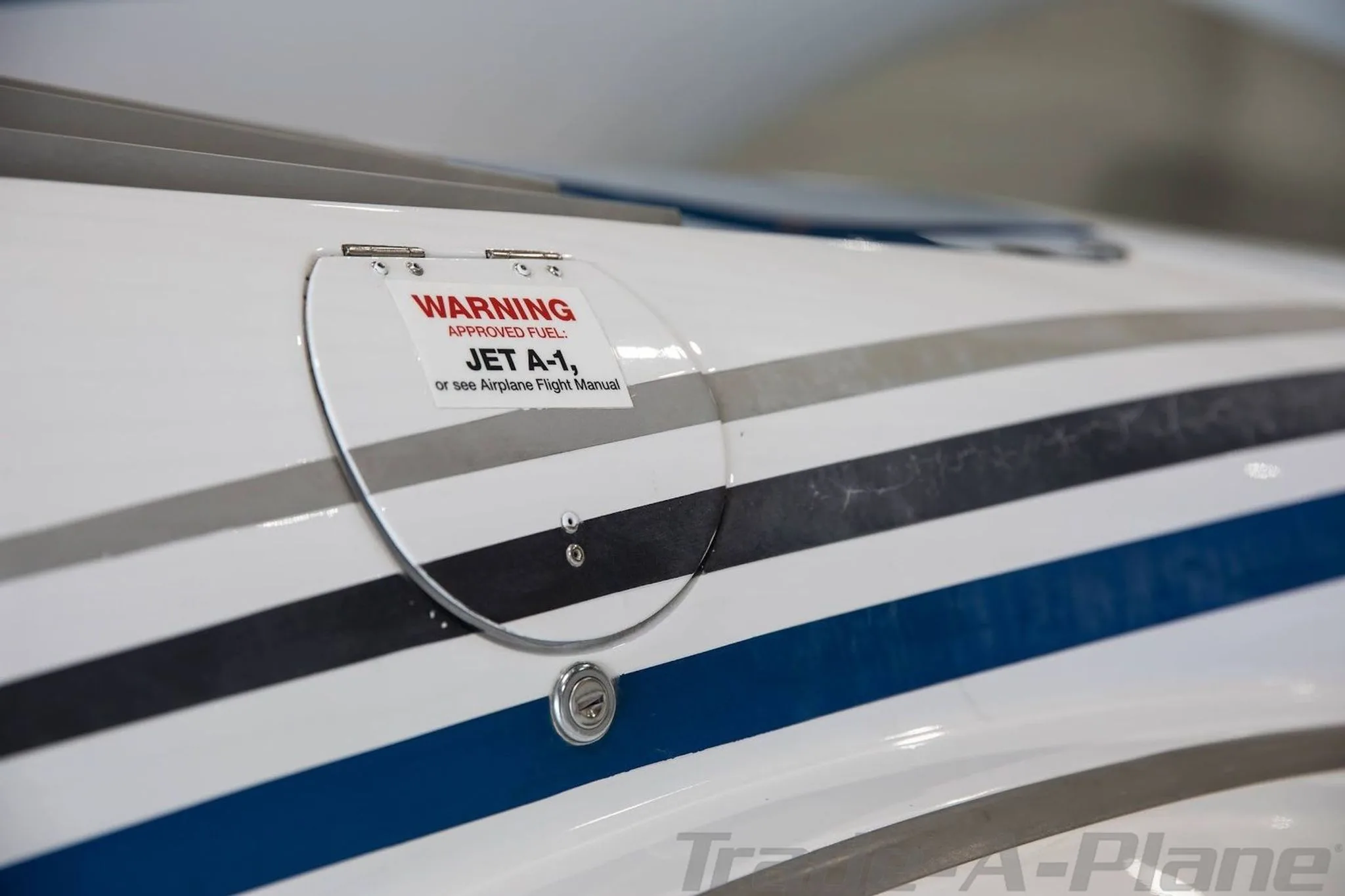 A close-up view of the fuel cap on the fuselage of a white Diamond DA42-NG aircraft, with a 'JET A-1' warning label.