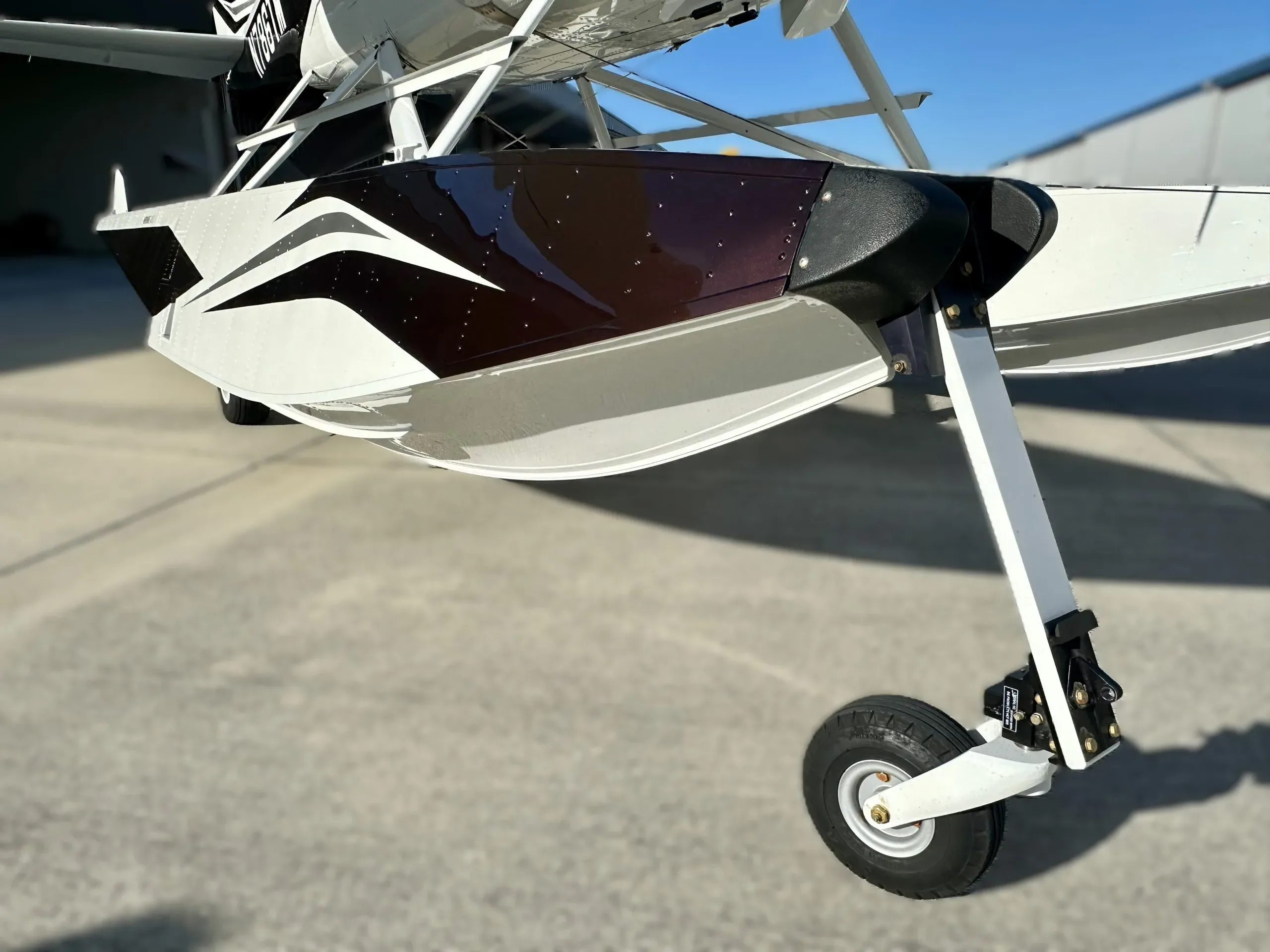 A close-up of the retractable landing gear and float of the Cessna seaplane.