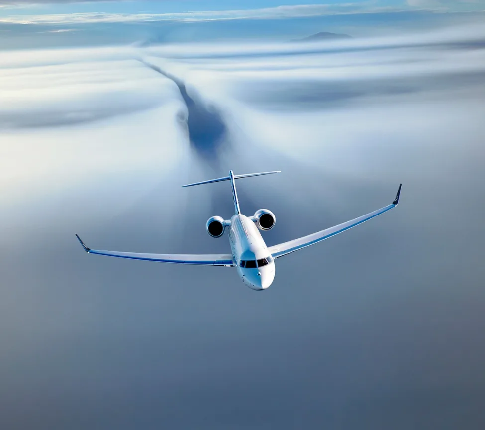 Luxurious aircraft interior with a bed and seating area.