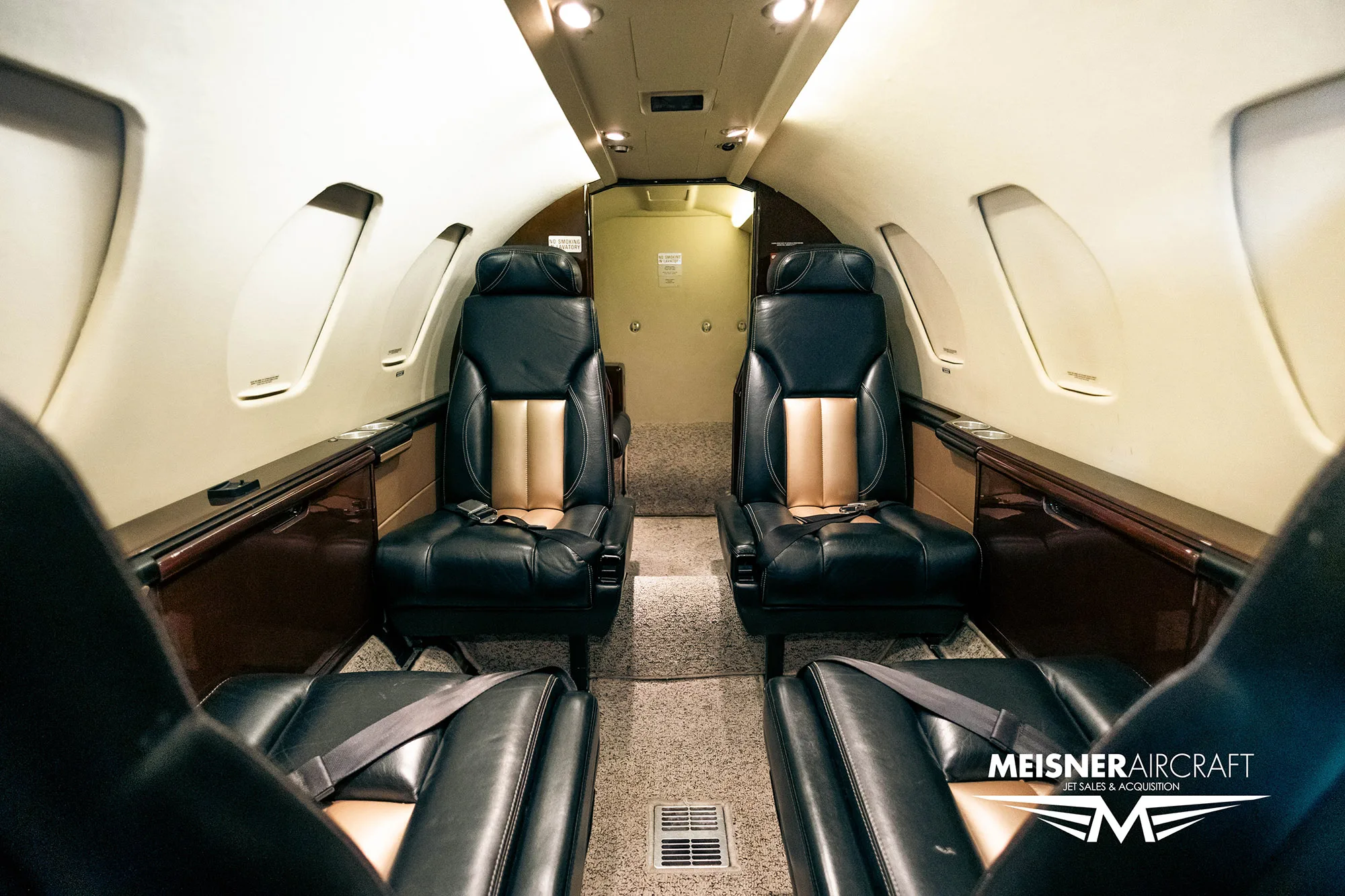 View of the aircraft interior from the rear, showing seats.