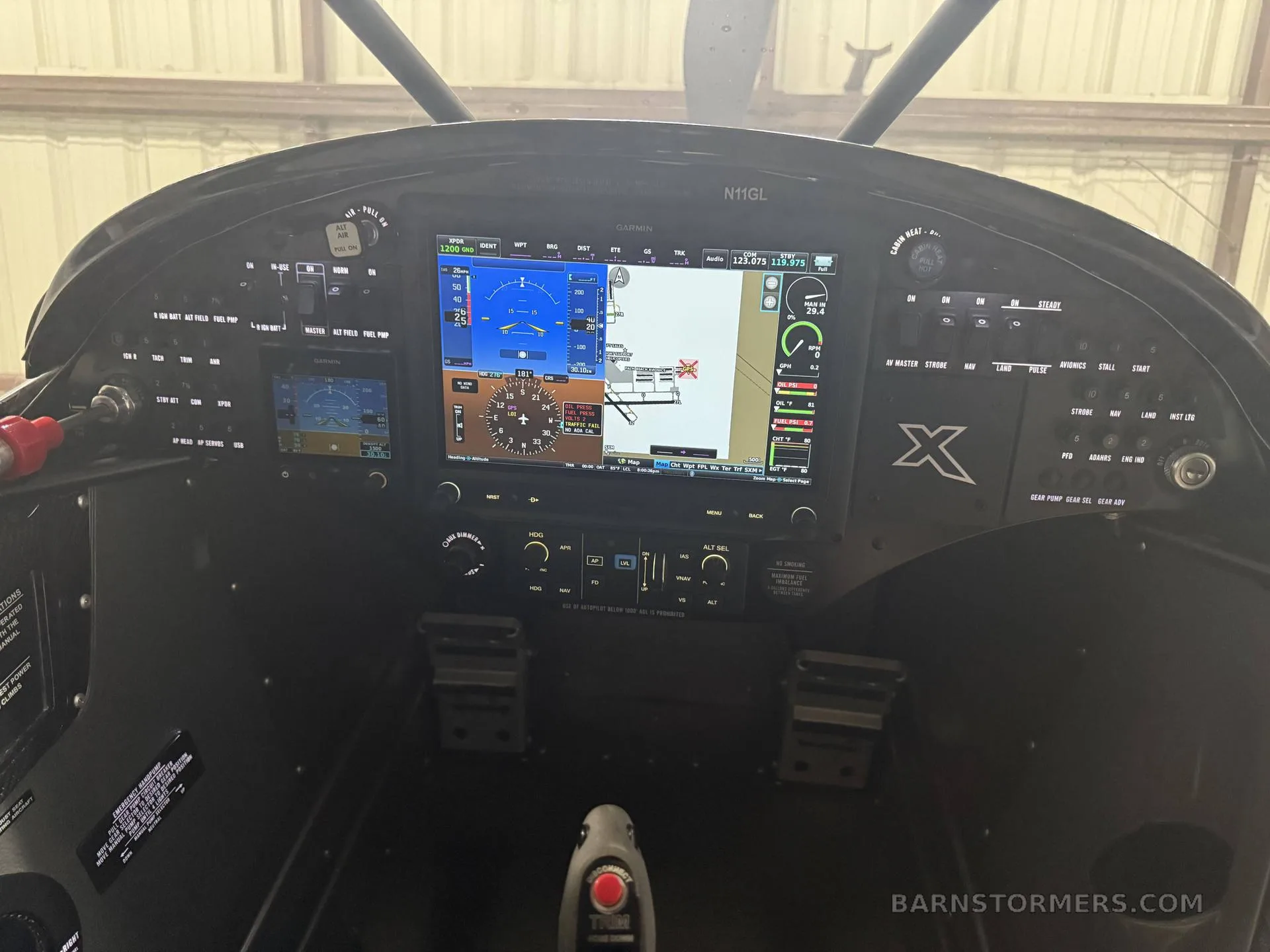 The modern glass cockpit of an X-Cub aircraft, featuring multiple Garmin display screens.