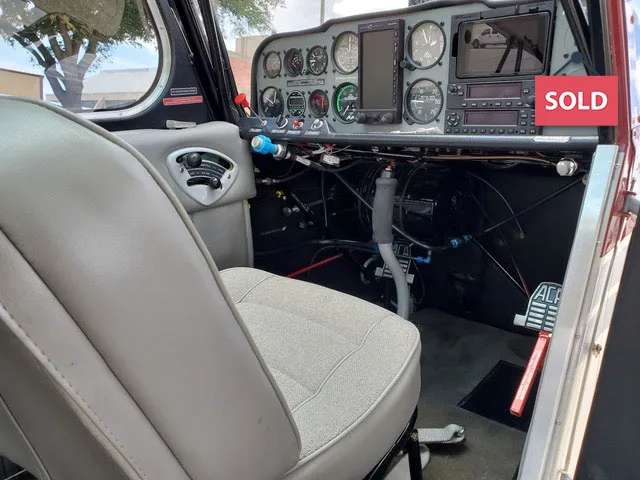 View of the aircraft's cockpit showing the instrument panel and controls.
