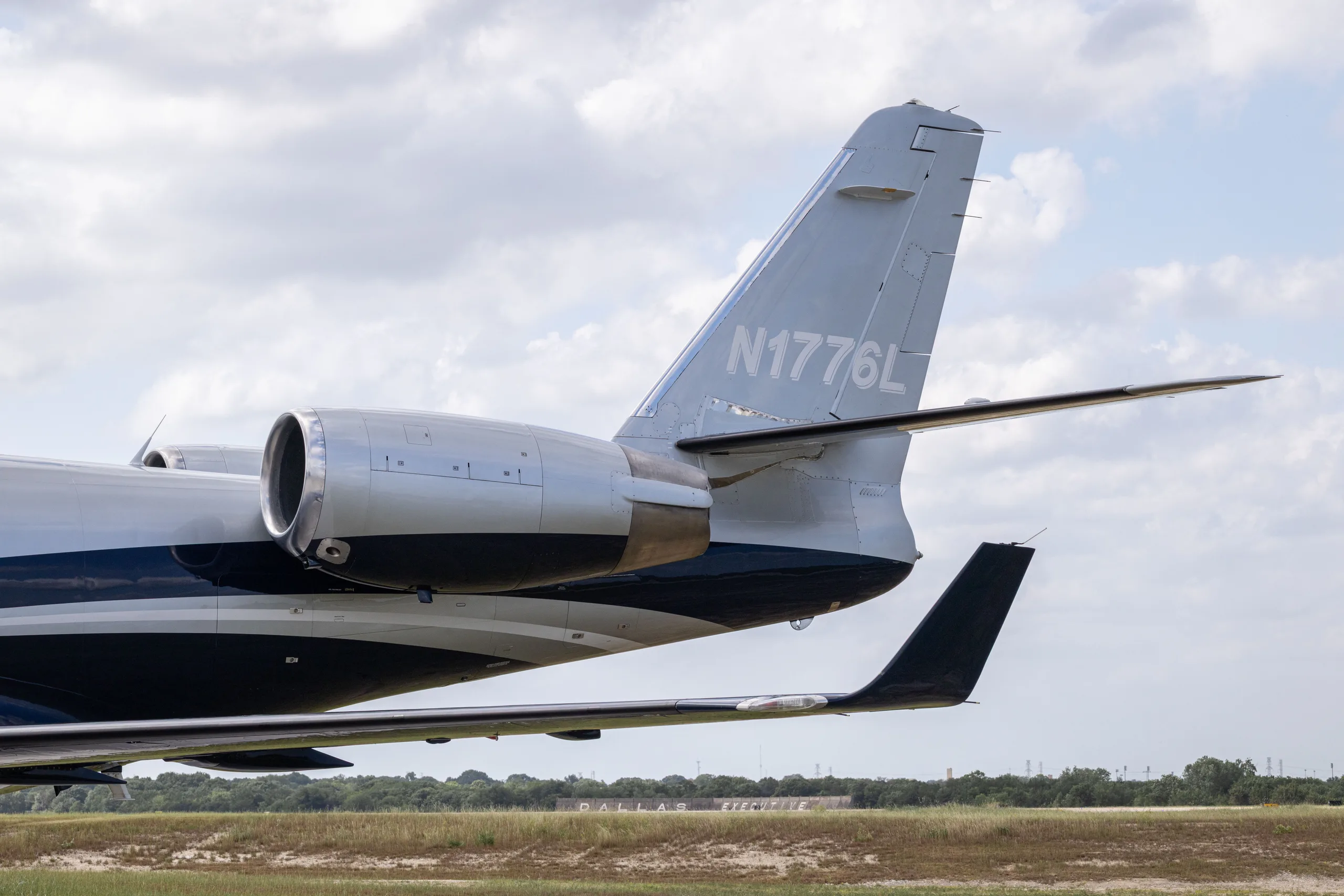 A close-up view of the tail and engine of a Learjet 60, showing the N1776L registration.