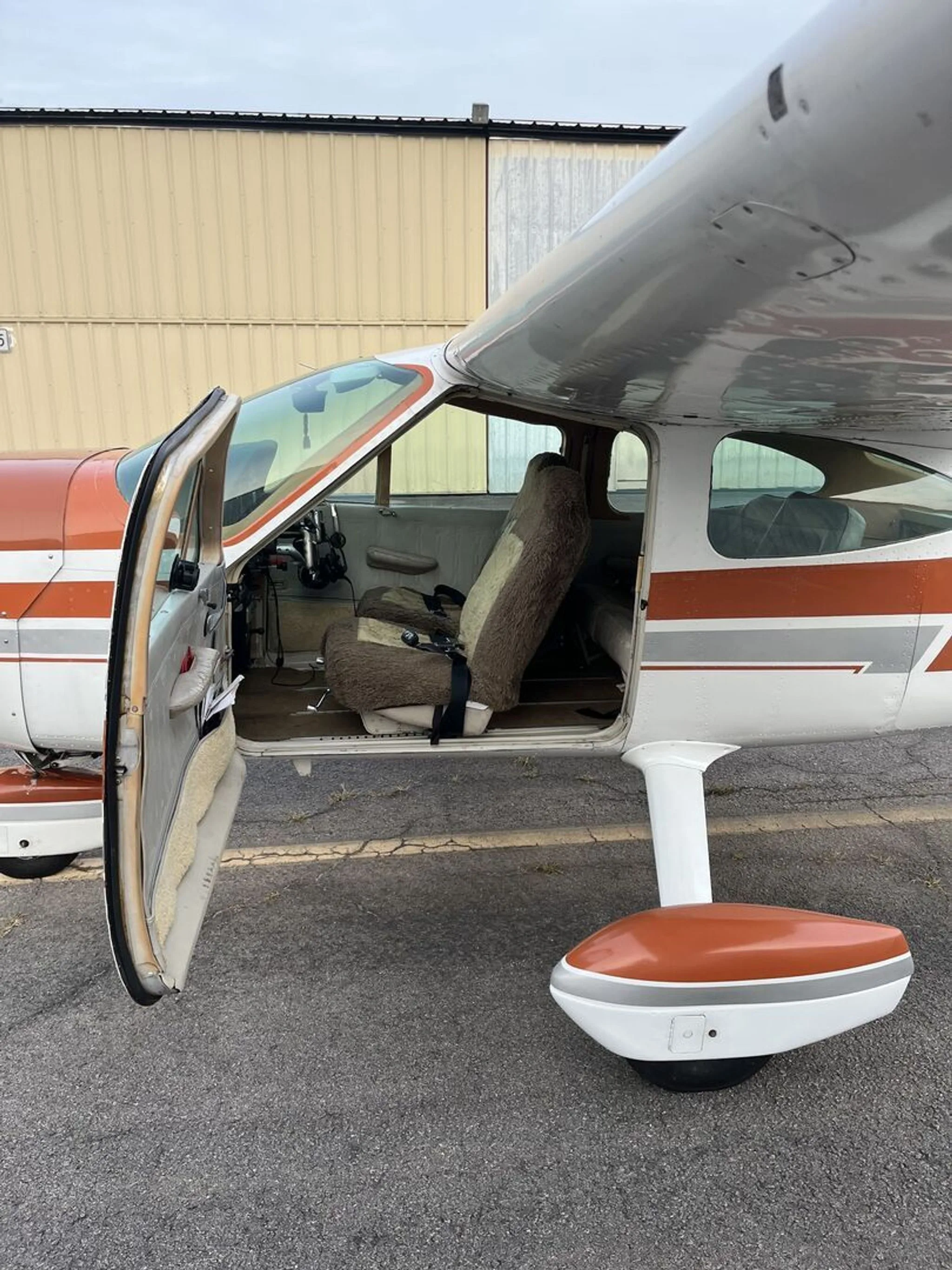 The aircraft door is open, showing the interior.