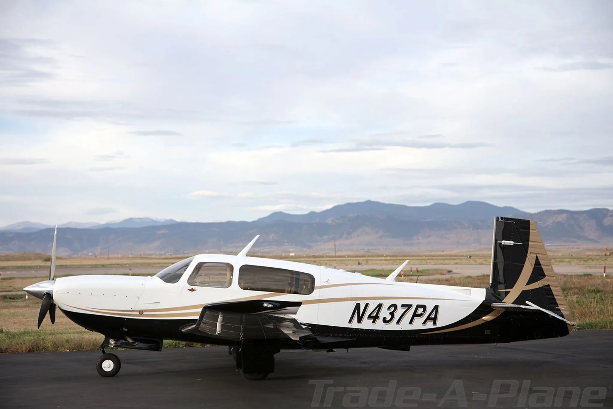 A side view of the aircraft parked on the ground.