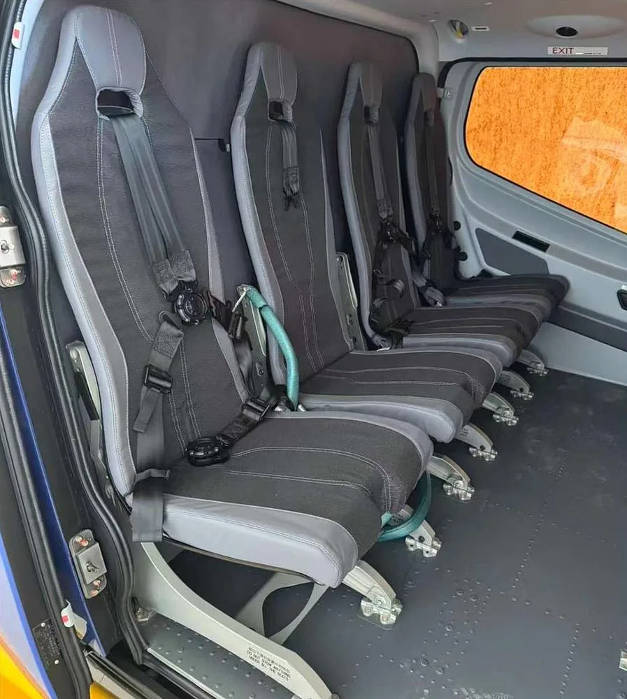 A close-up view of the grey and black passenger seats in the helicopter's cabin.