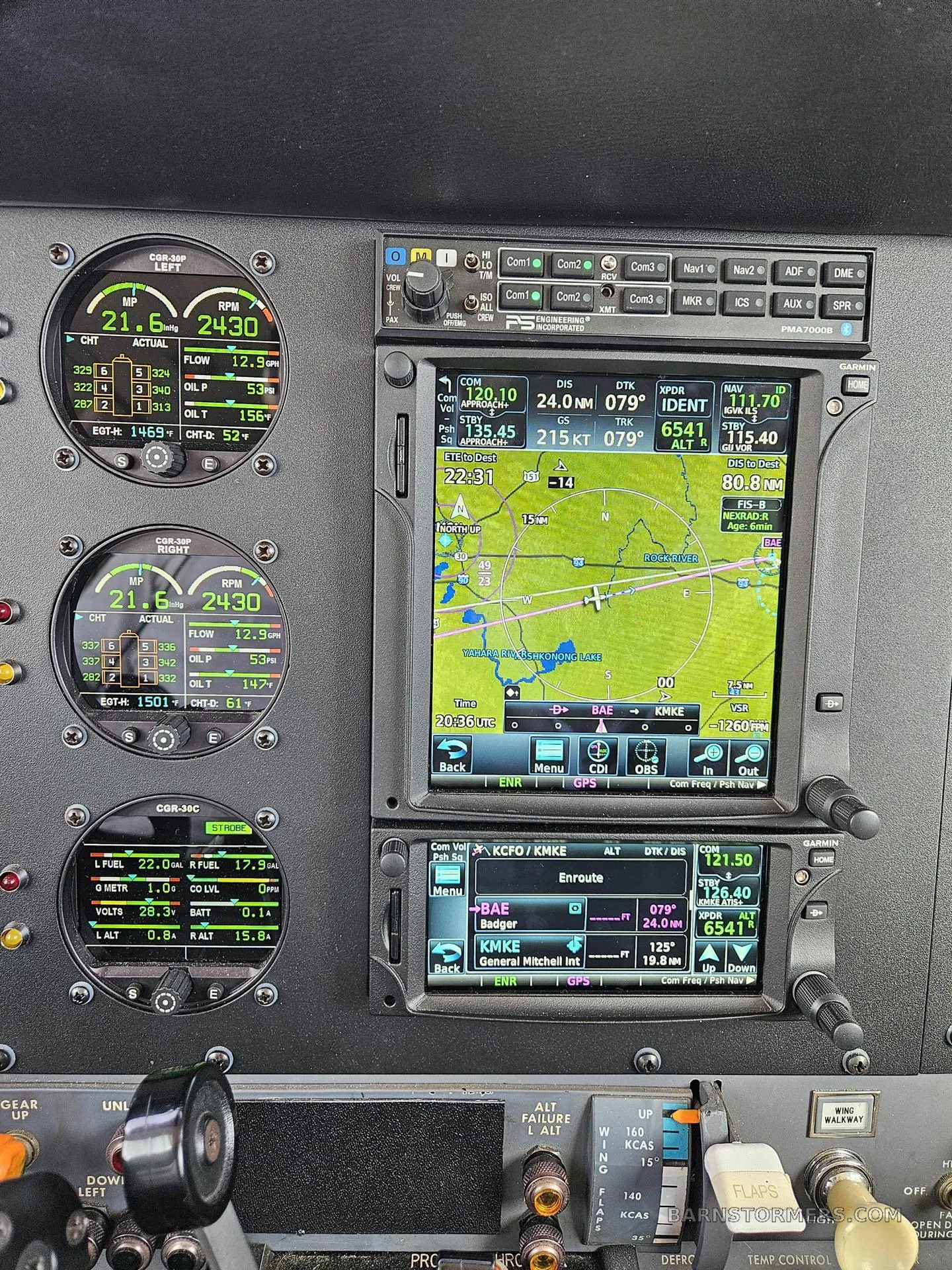 A close-up of the aircraft's instrument panel, highlighting the digital engine monitors and GPS navigation display.
