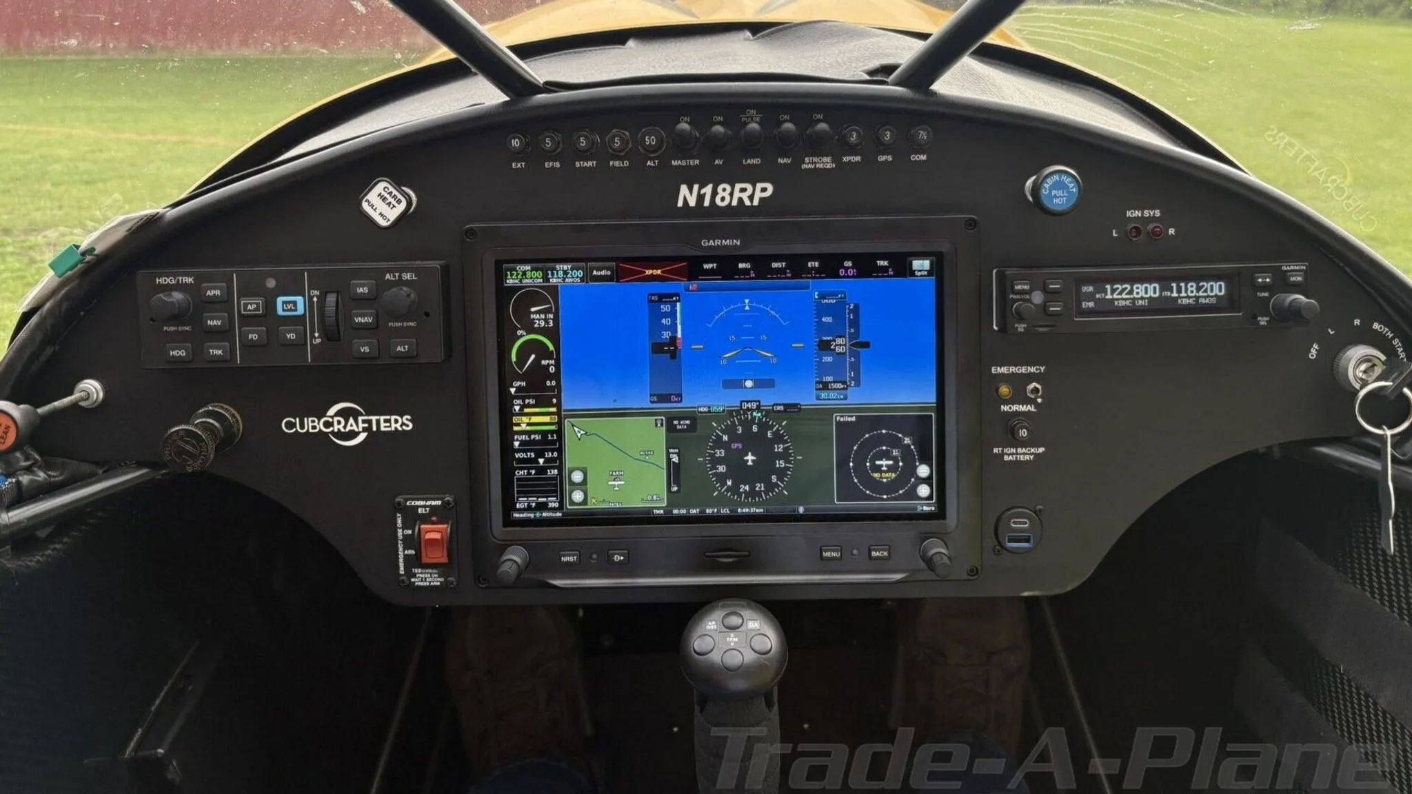 The cockpit of the CubCrafters Carbon Cub N18RP, featuring a large Garmin G3X Touch display and traditional controls.