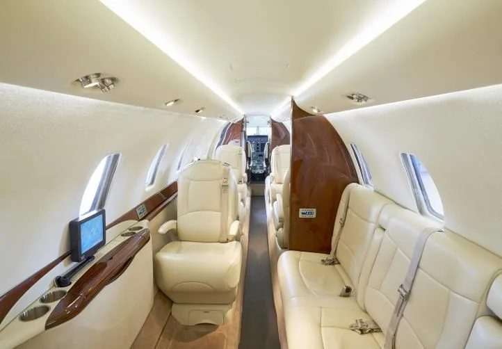 A view down the aisle of the aircraft cabin, showing the seating arrangement and interior finishes.