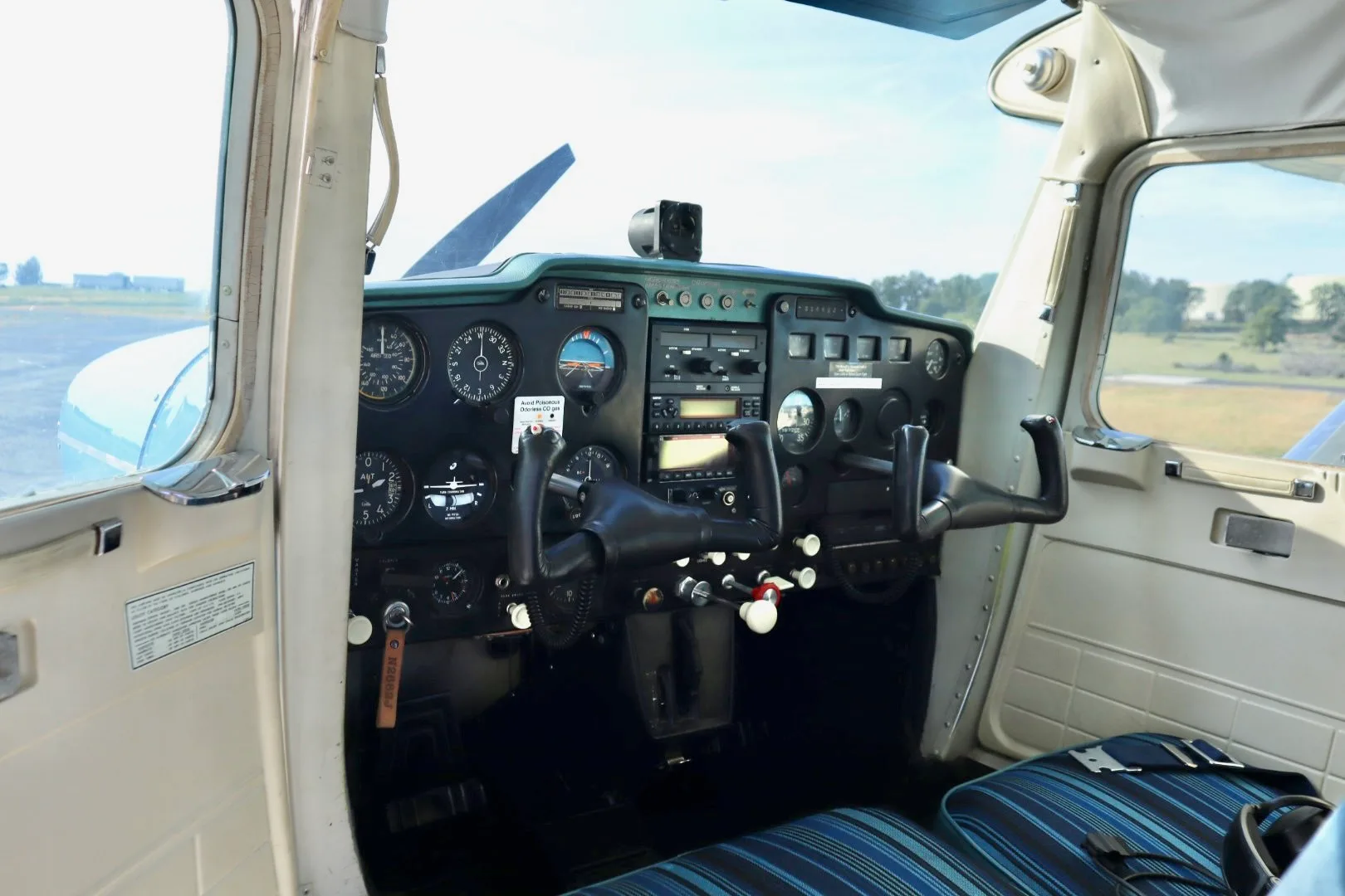 The instrument panel and controls of a Cessna 150 cockpit, viewed from the passenger side.
