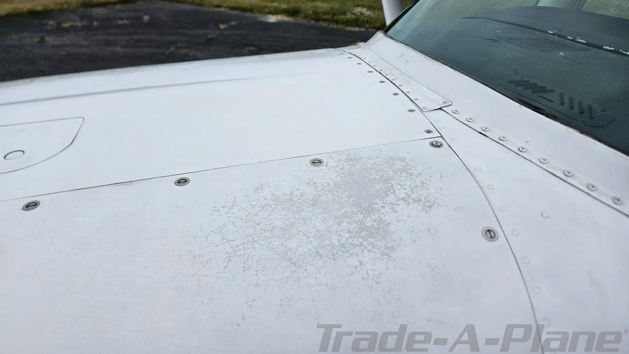 A close-up view of the top of the white fuselage of the Cessna 182, showing some paint wear.
