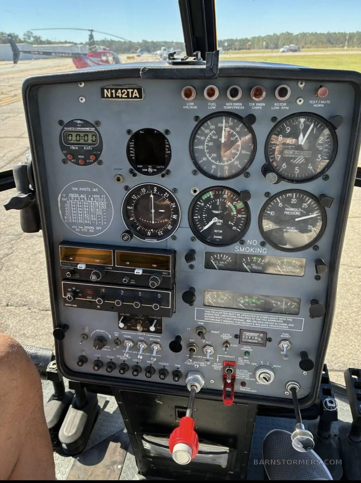 The instrument panel of a Schweizer 300CBi helicopter (N142TA) with various gauges and controls.