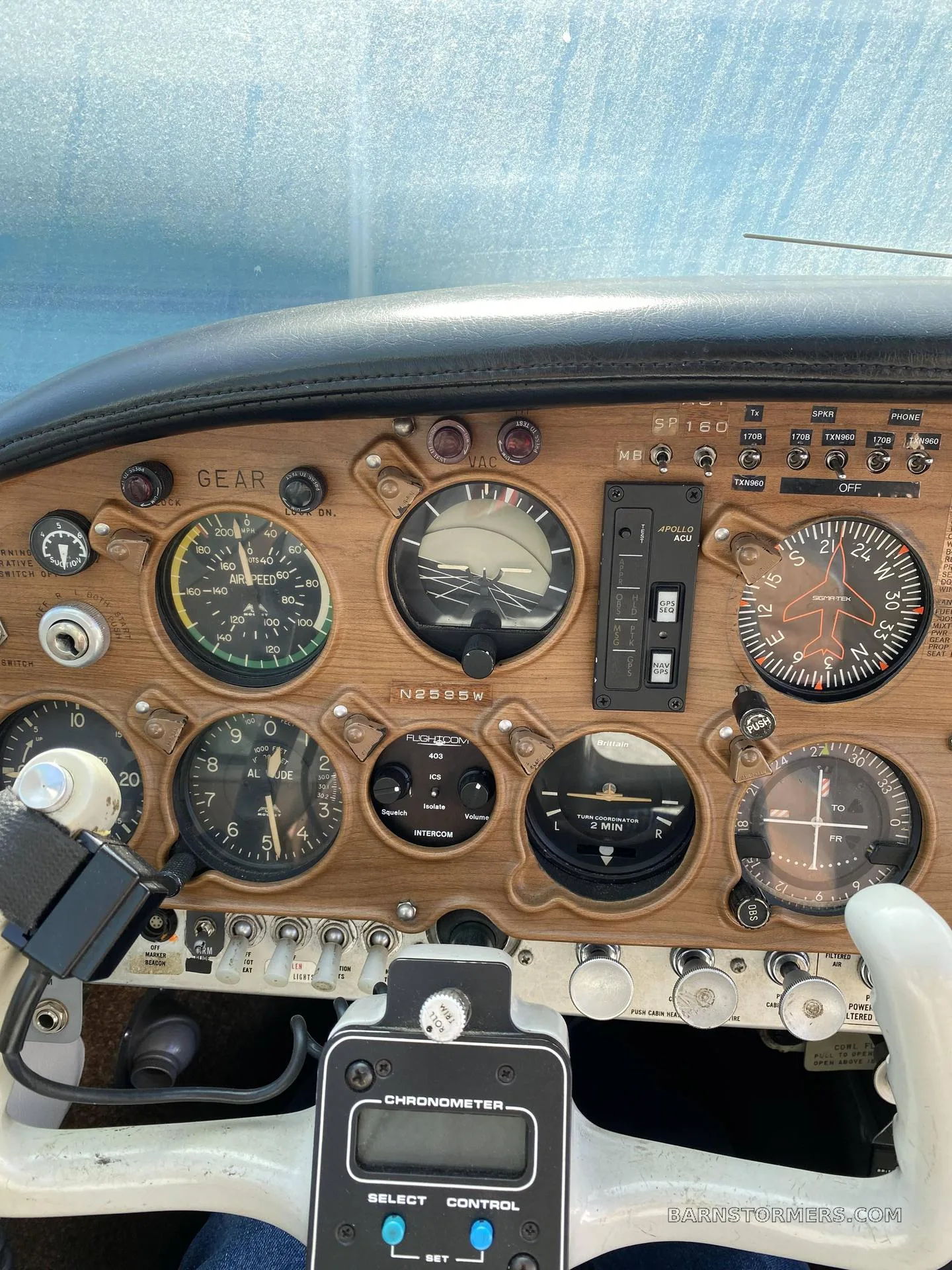 Close-up view of the aircraft's instrument panel, showing gauges, controls, and a white yoke.