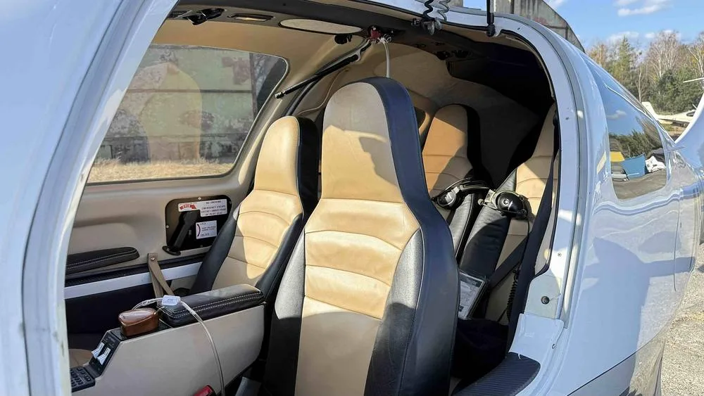 The tan and black leather seats of the Columbia 400 aircraft cabin.
