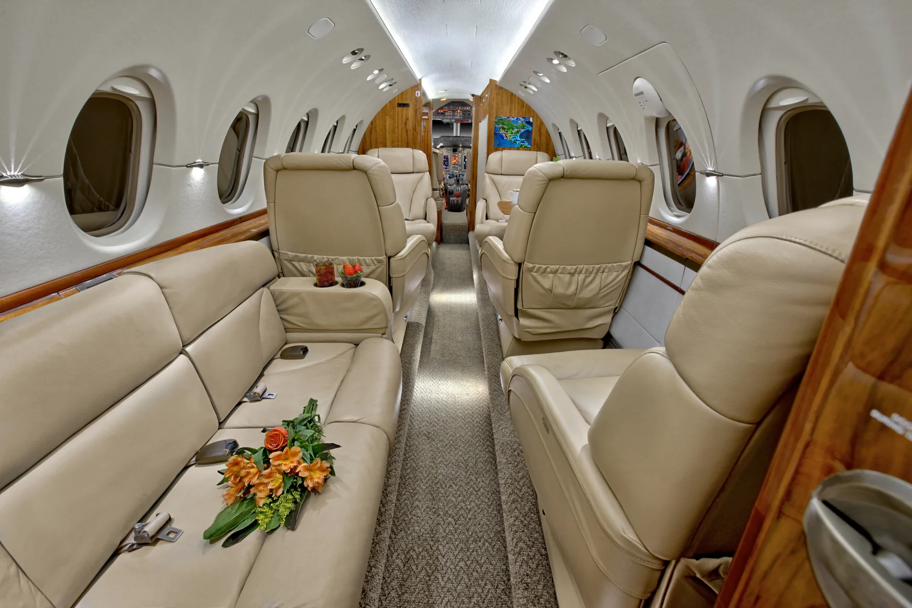 A view of the aircraft's interior with leather seats and wood trim.