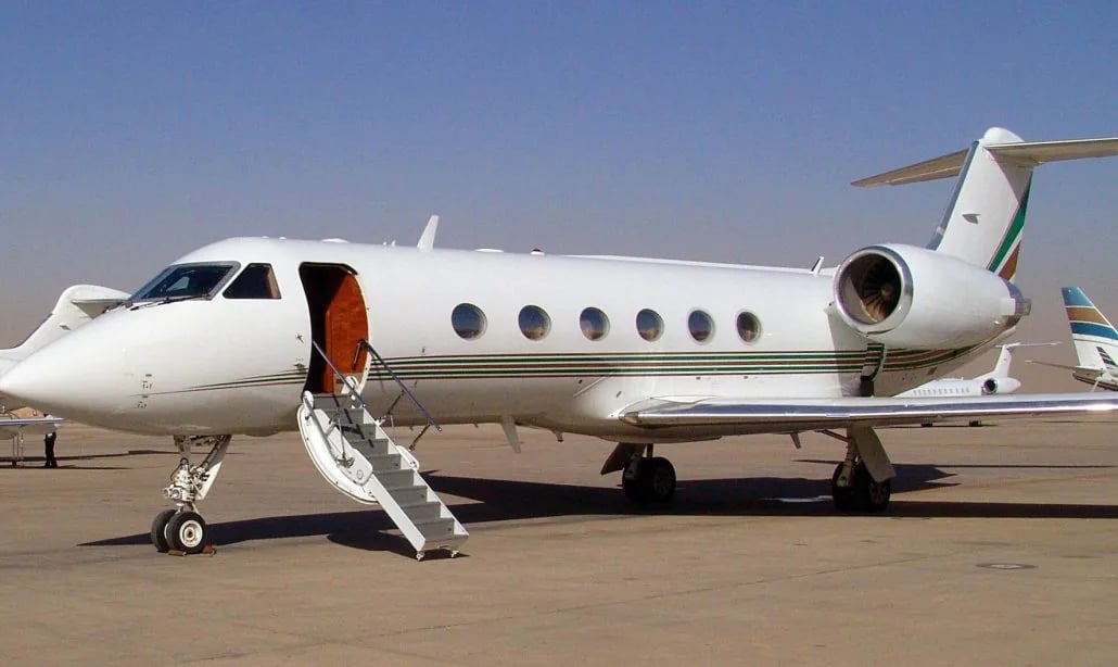 A white jet with an open door and stairs extended.