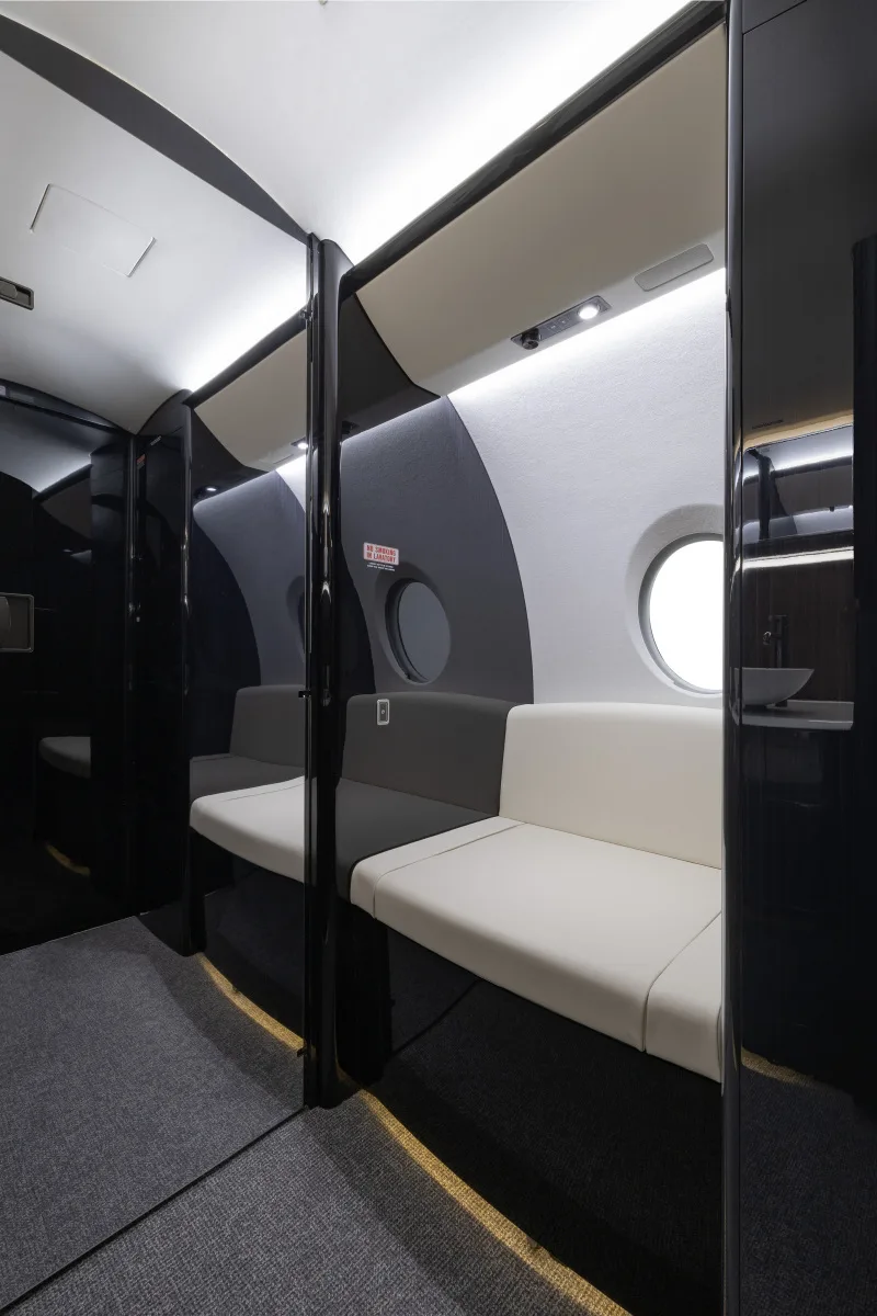 Interior view of the aircraft cabin with seating and a window.