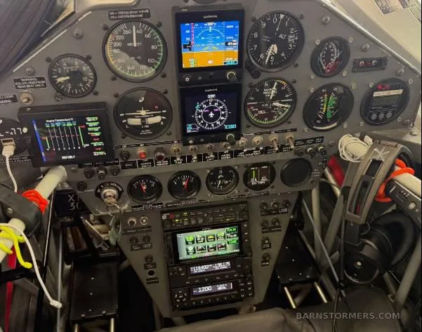 The cockpit instrument panel of an aircraft, featuring a mix of analog gauges and modern digital displays.