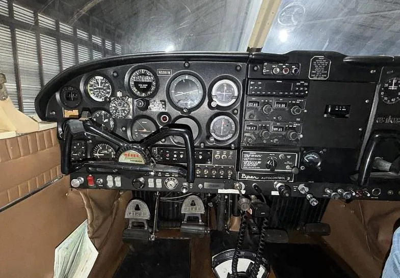 The cockpit instrument panel of a Piper Cherokee Six, showing gauges and avionics.