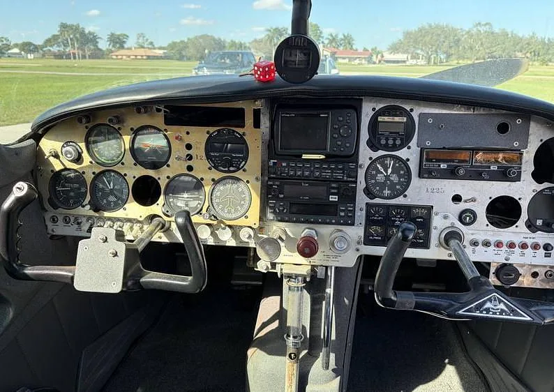A detailed view of the aircraft's instrument panel with various gauges and avionics.