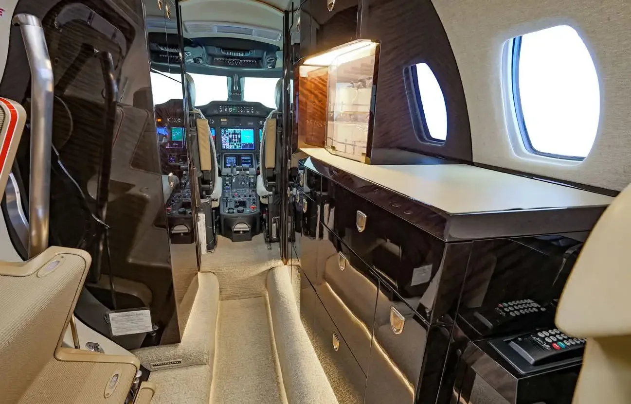 View from the aircraft cabin looking forward into the galley area and towards the cockpit.