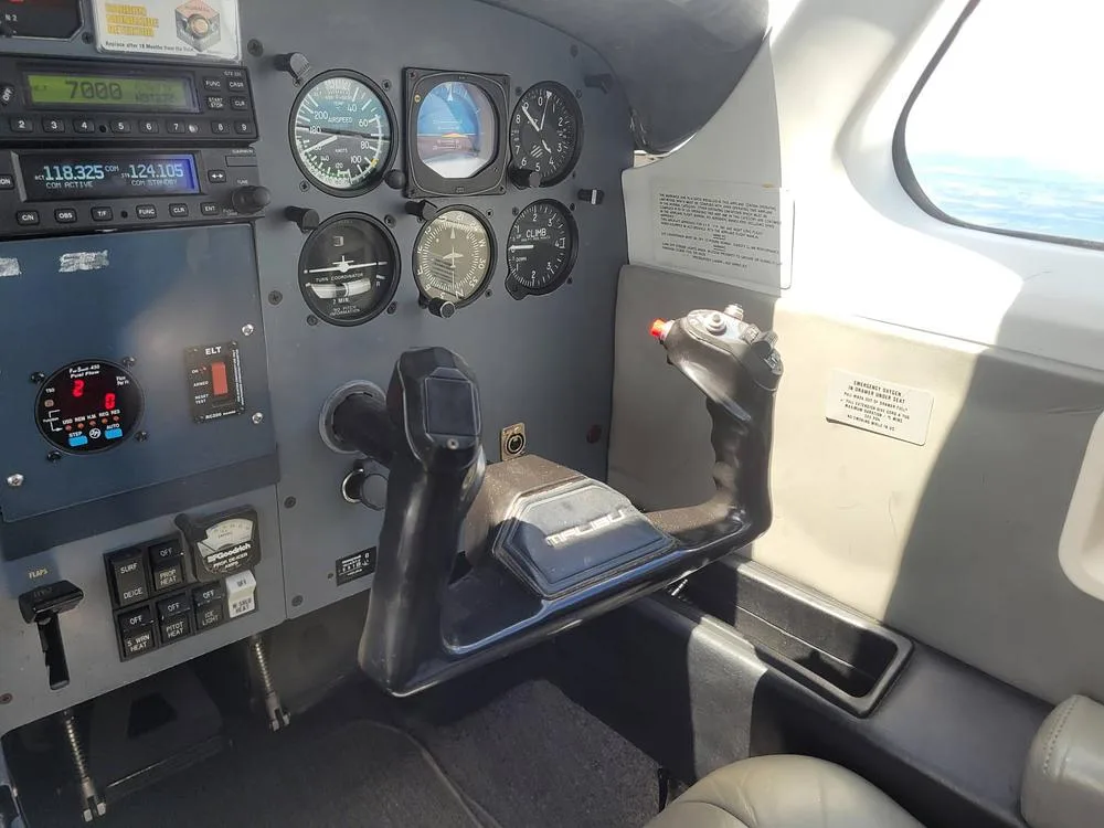 The pilot's side of a Piper PA-46-350P Malibu Mirage cockpit, showing the control yoke and a section of the instrument panel.