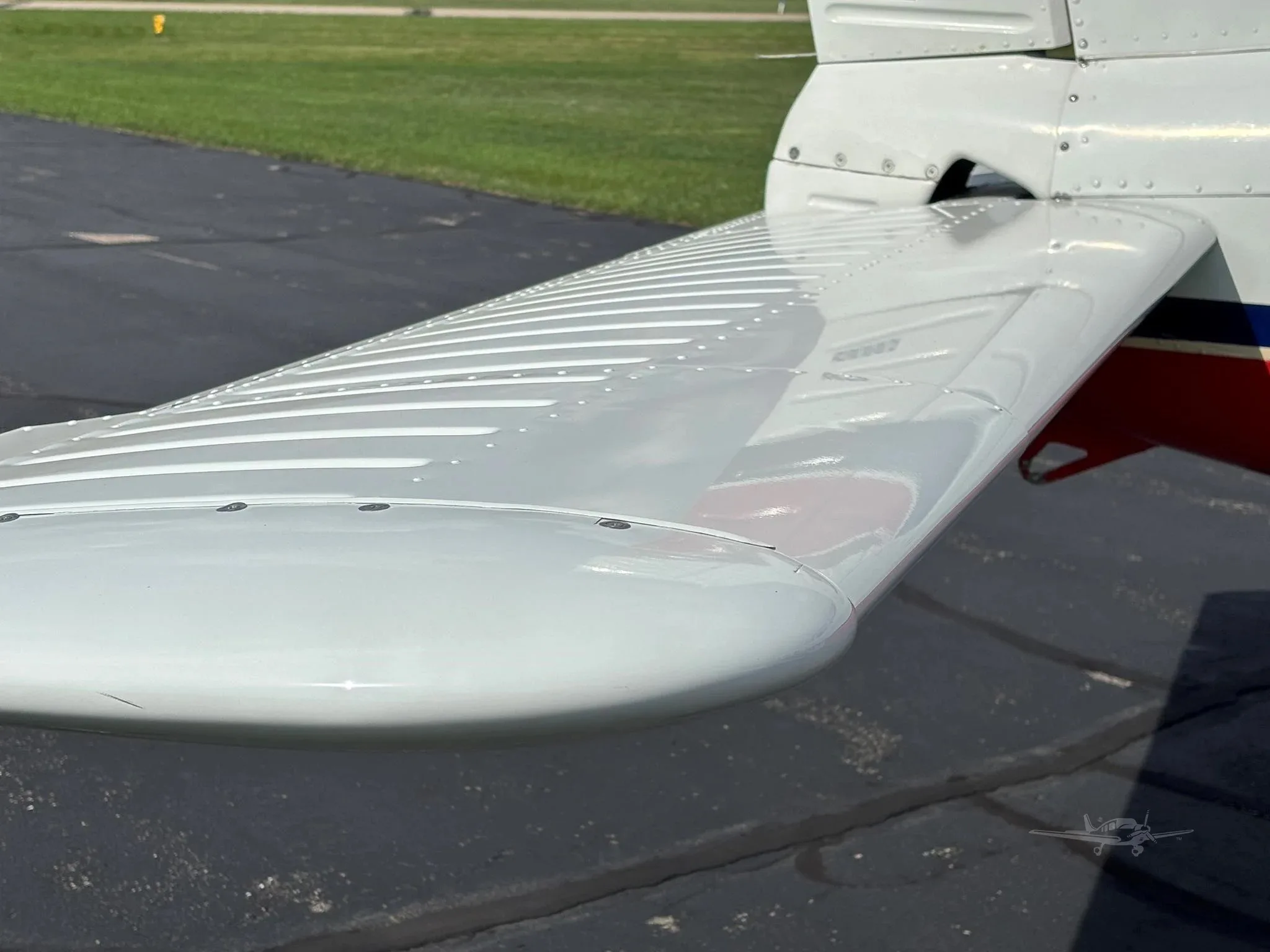 A close-up view of the white horizontal stabilizer of the aircraft.