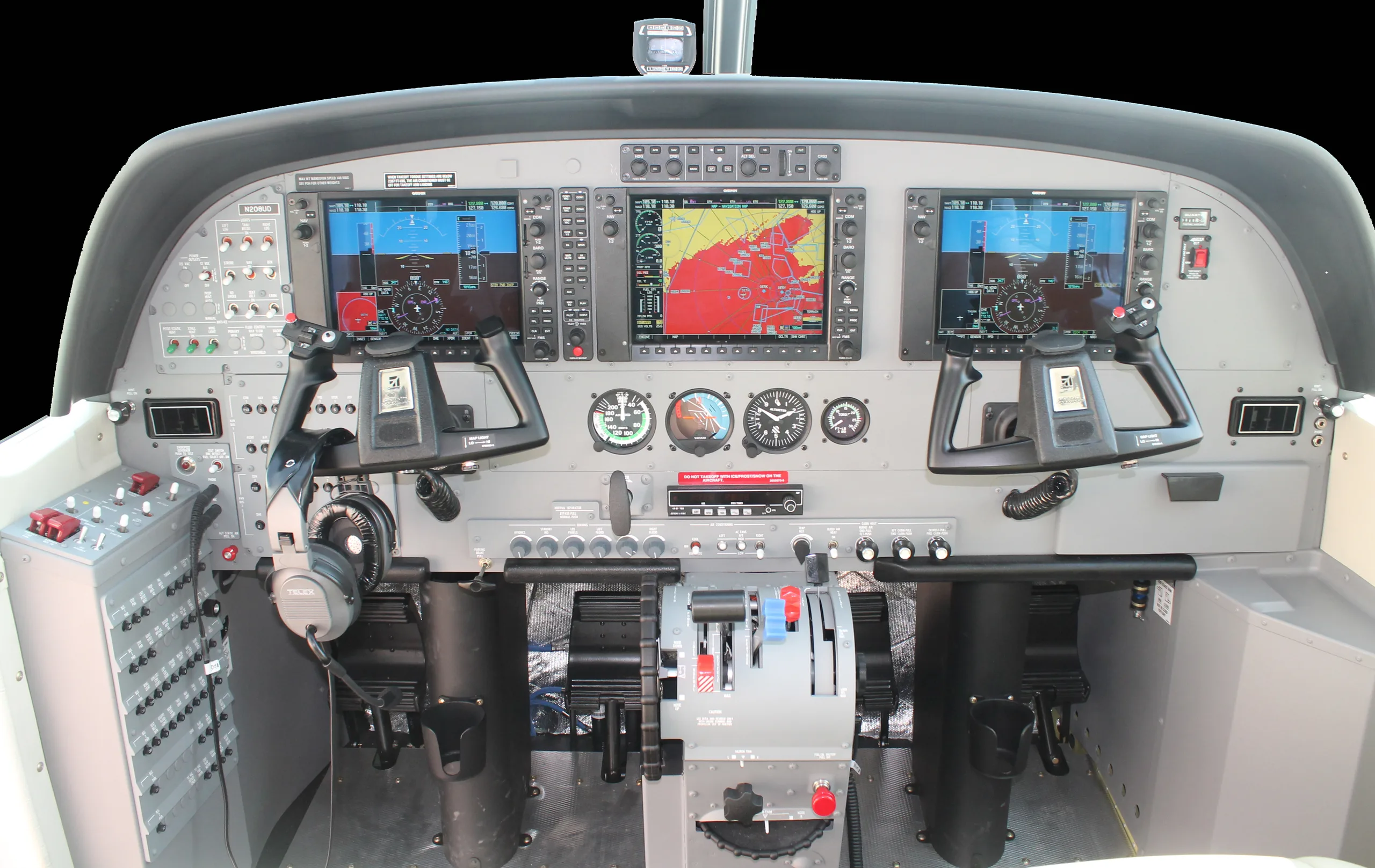 The cockpit of an aircraft features a modern glass panel with two large displays and traditional gauges.