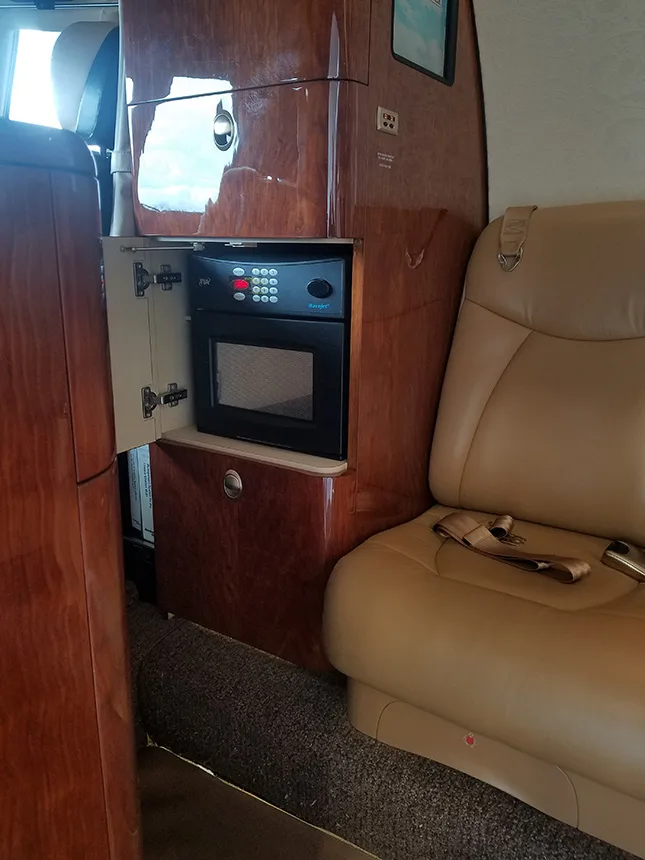 Interior view of the aircraft with a seat and a microwave.