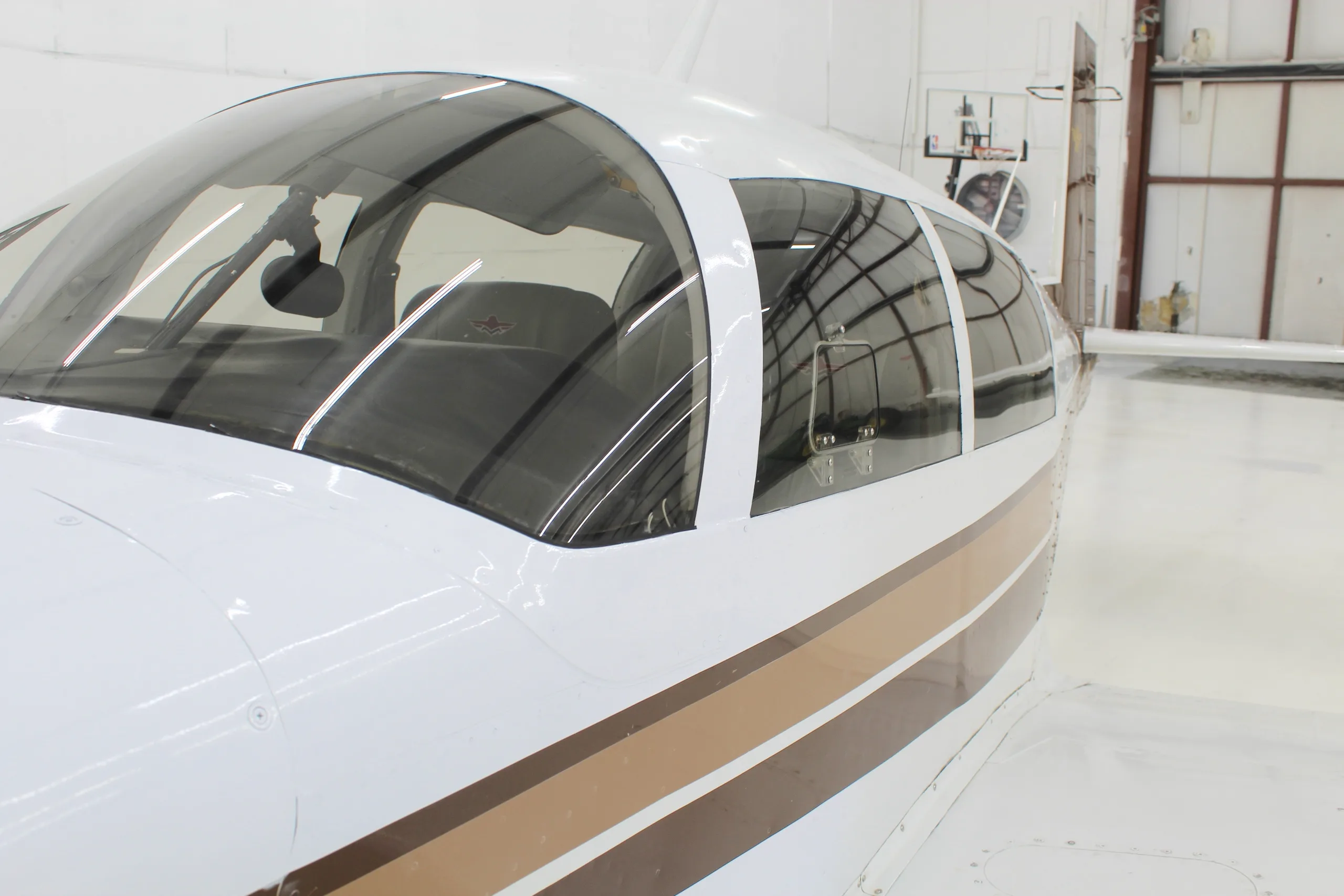Close-up of the cockpit area of a Mooney M20J aircraft with registration N4341H.