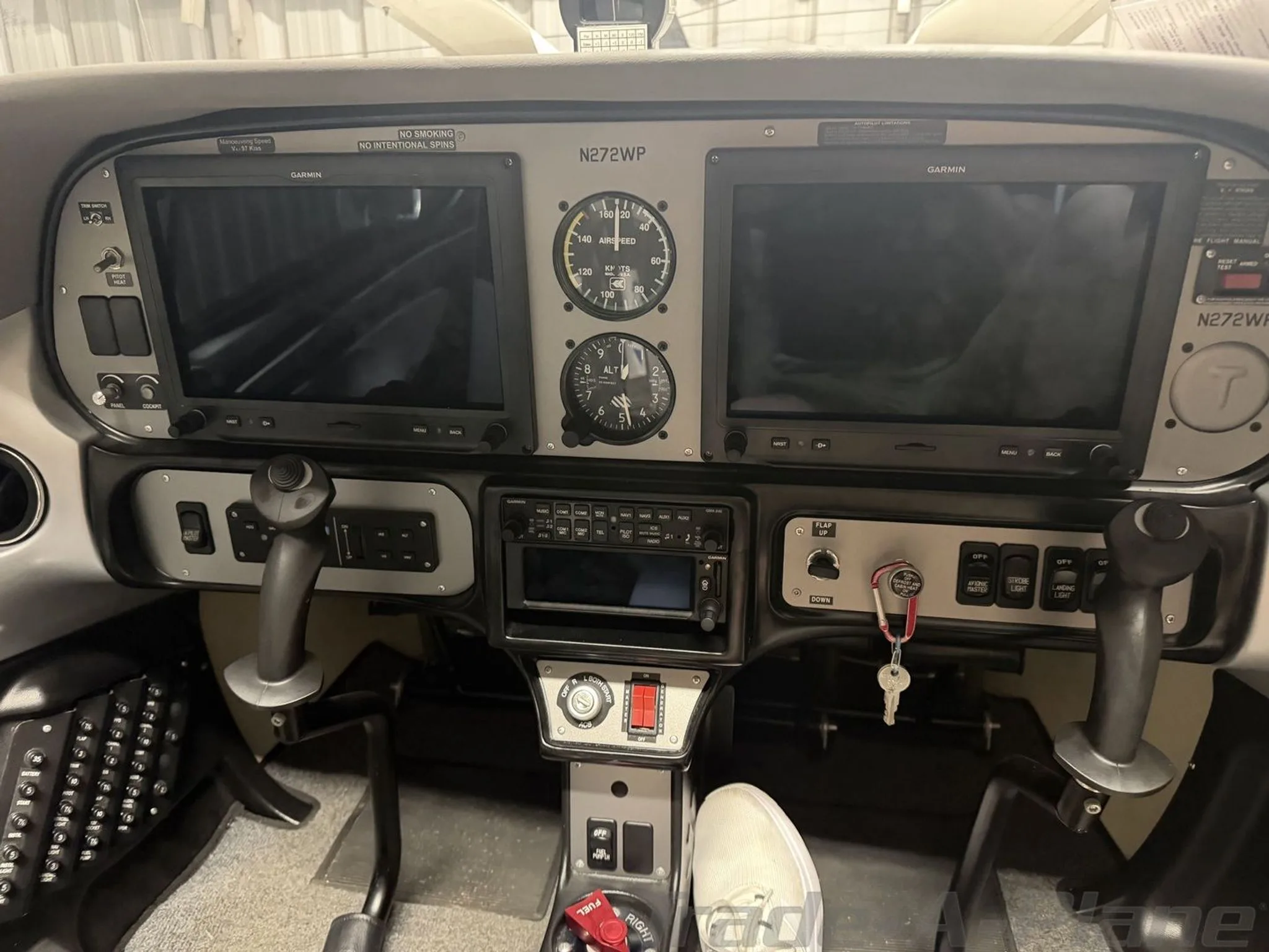 The cockpit of a Tecnam P2002 Sierra showing two Garmin G3X Touch displays, analog gauges, and control sticks.