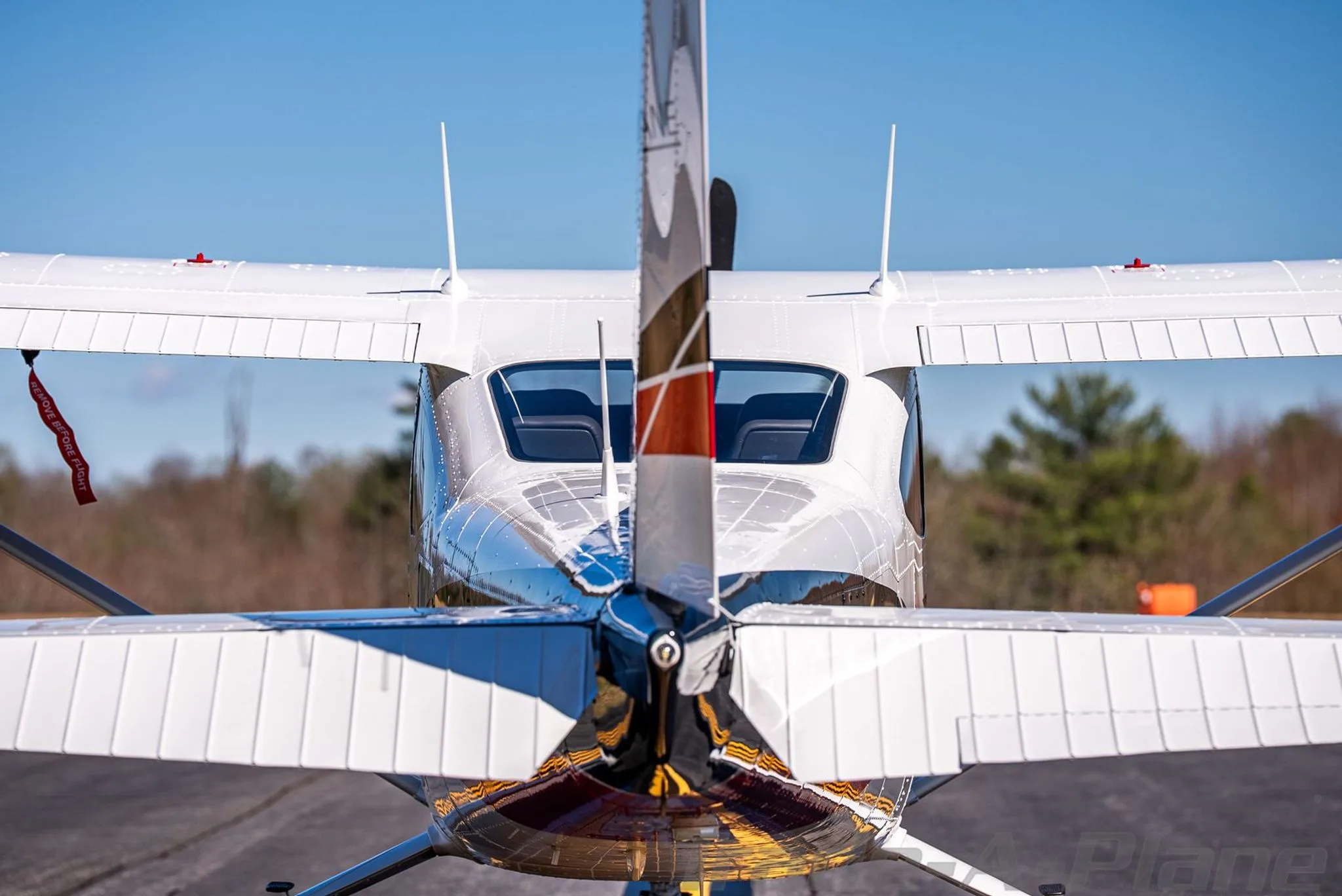A rear view of the white Cessna Skylane N32LP, highlighting the tail and rear windows.