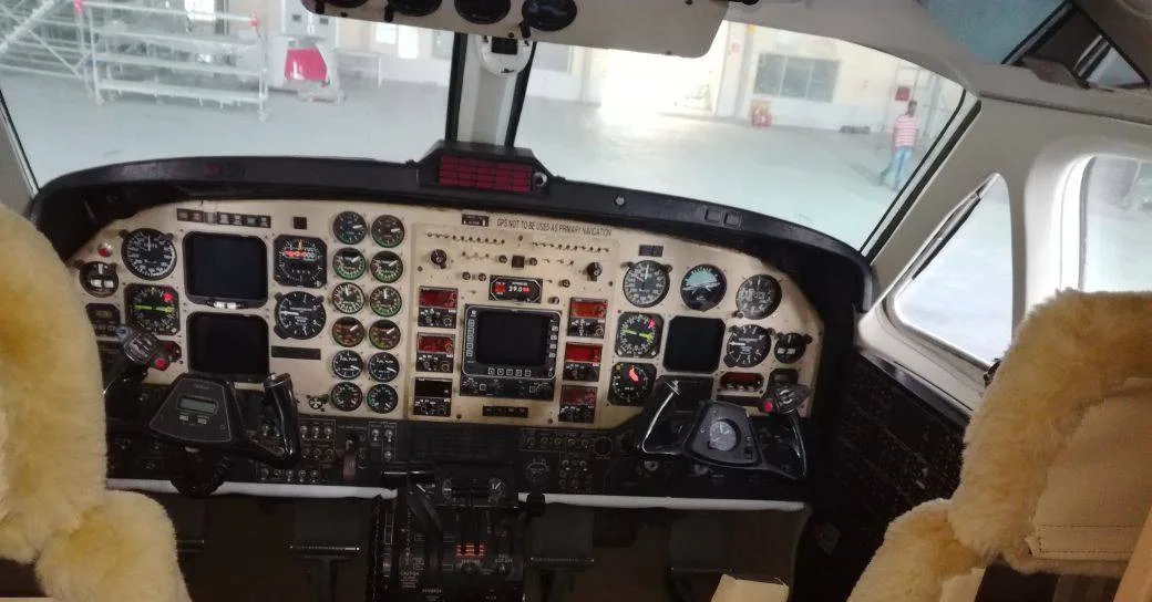The cockpit instrument panel of a turboprop aircraft with numerous gauges and controls.