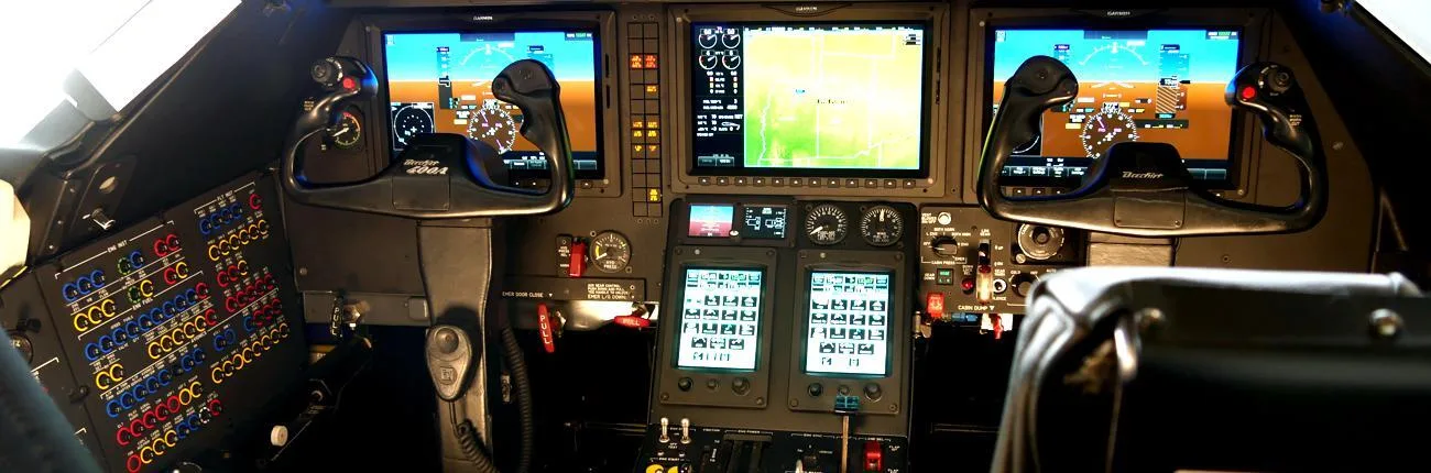 The cockpit of a Beechjet 400A with multiple digital displays and control yokes.