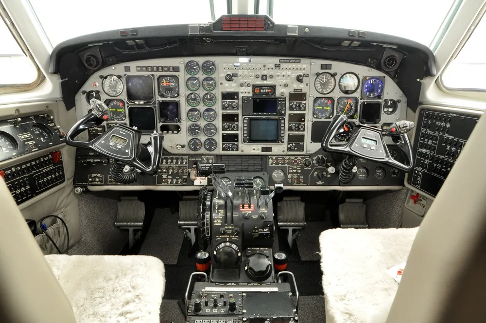 The detailed cockpit of the aircraft, showing a complex array of analog gauges, digital displays, and control yokes.