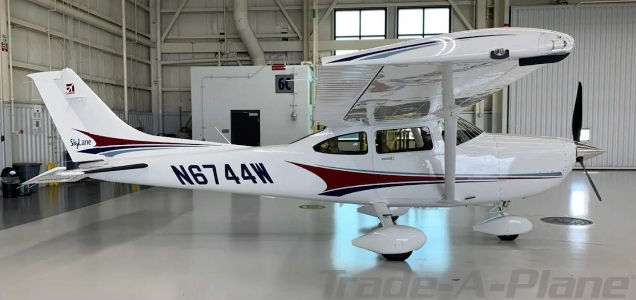 A side view of the Cessna 182T Skylane in a hangar.