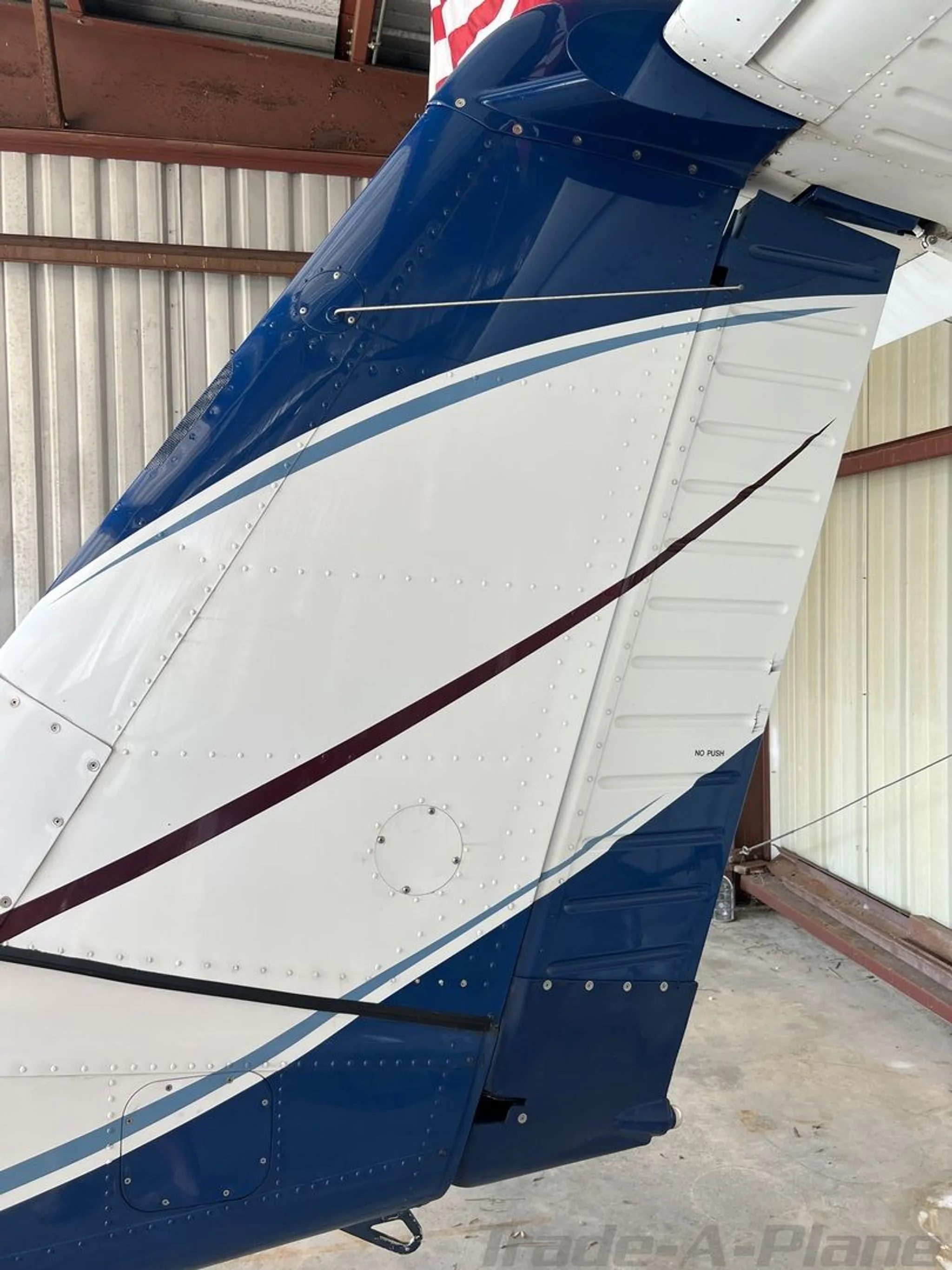 A detailed close-up of the blue and white tail section of the Piper Archer II (N2248X).