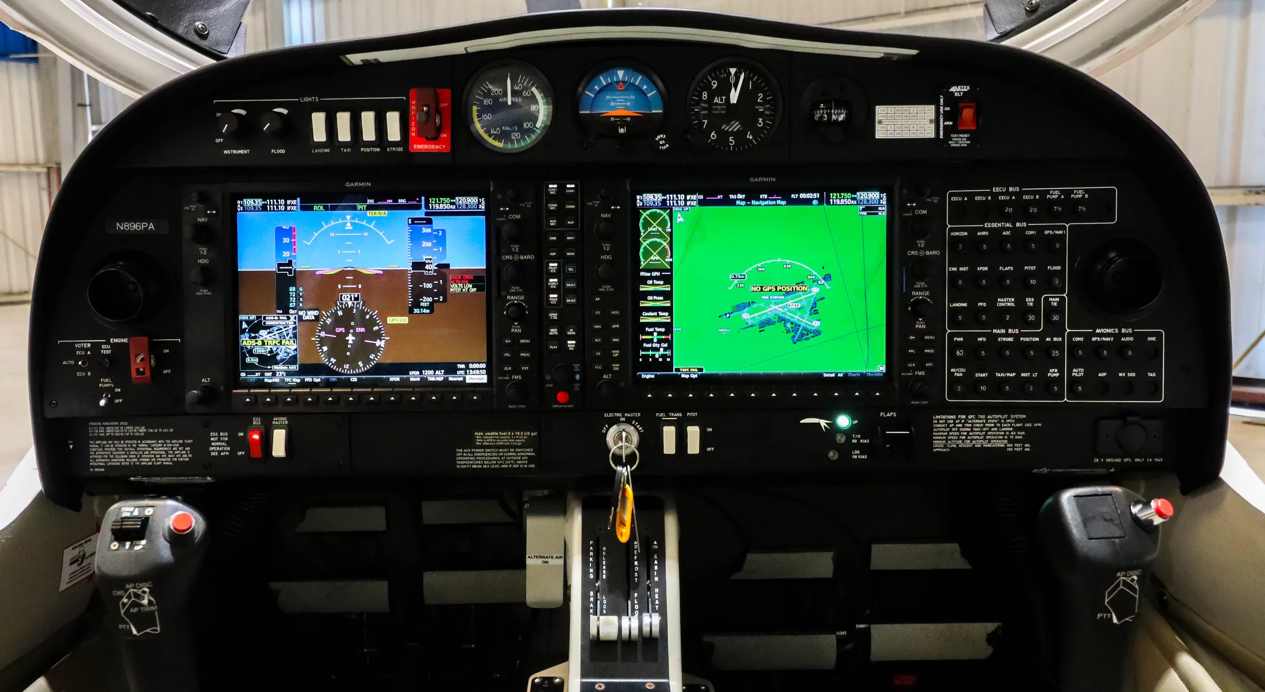 The cockpit of a Diamond DA40 aircraft, showing the instrument panel with multiple digital displays and controls.