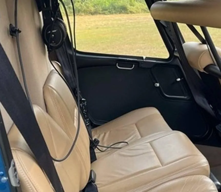 The tan leather seats in the interior cabin of the helicopter.
