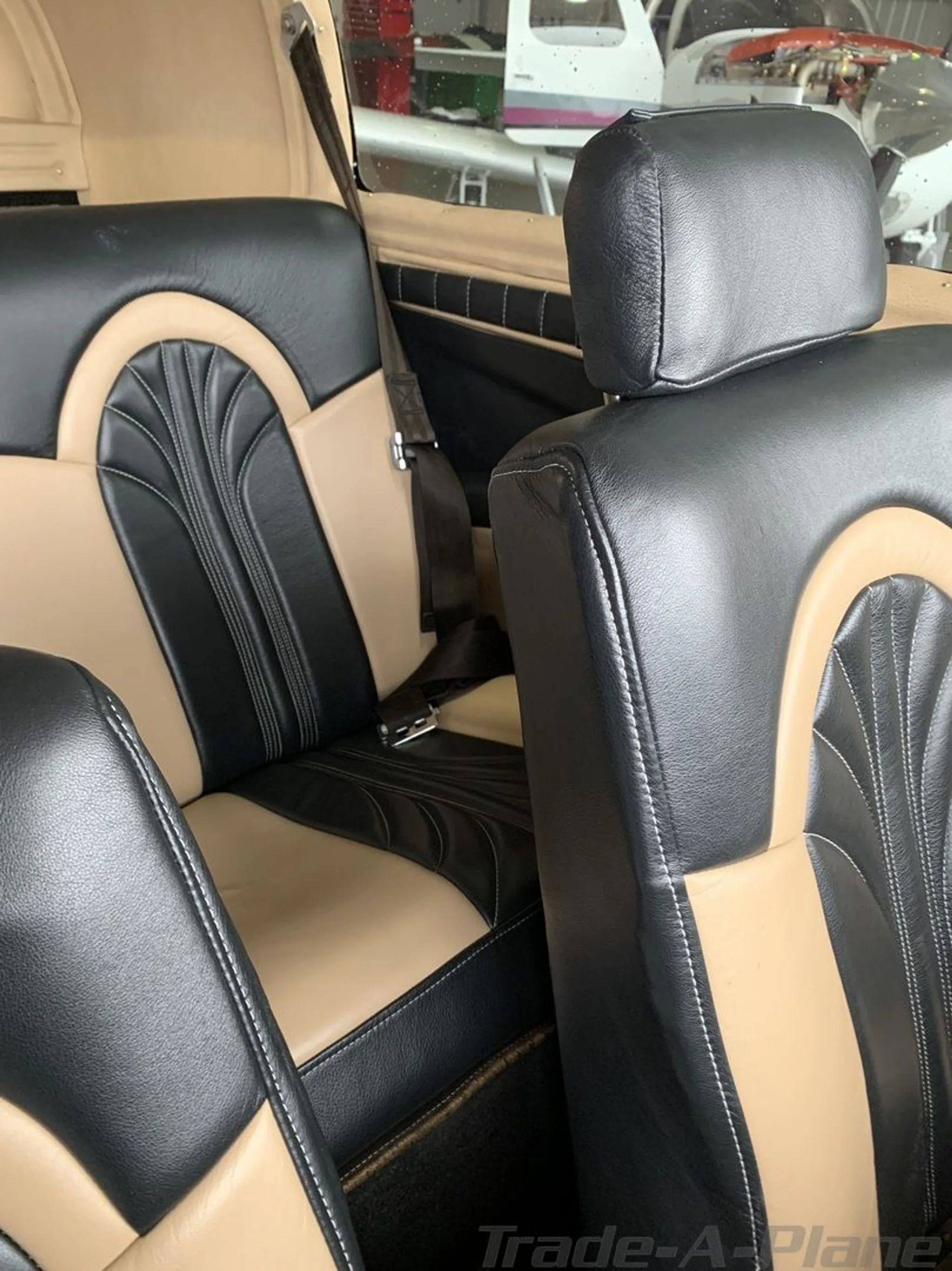 Close-up view of the aircraft's black and tan leather interior seats.
