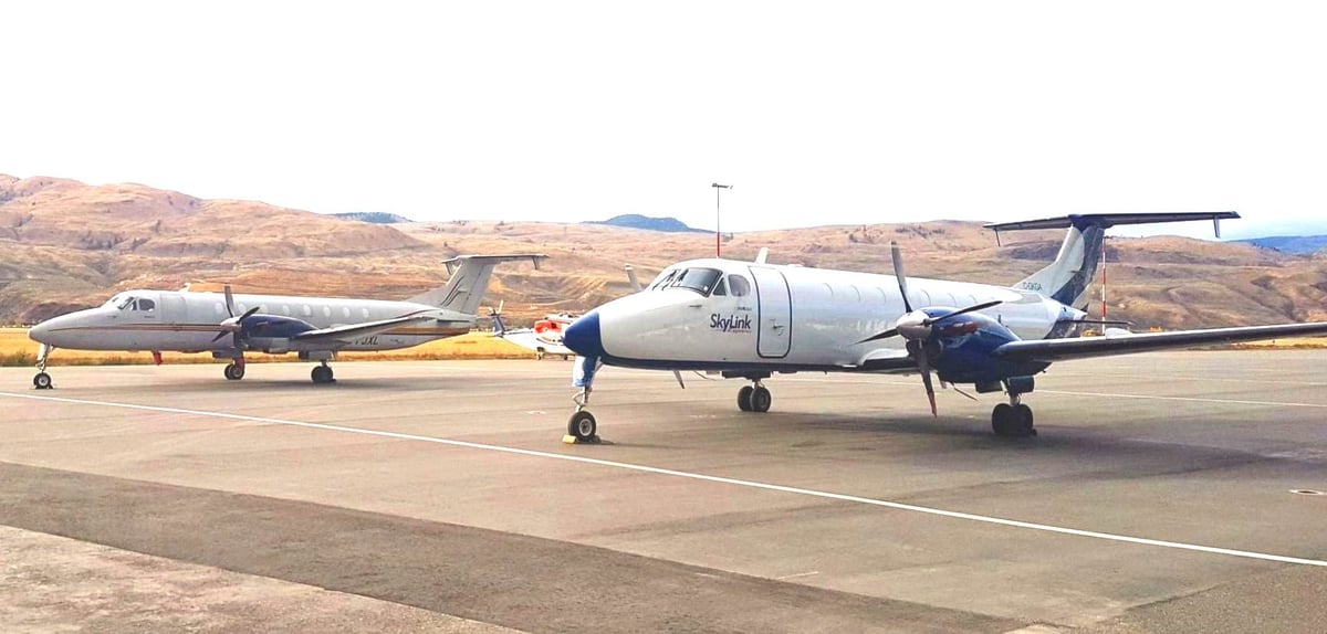 Two Beechcraft 1900C aircraft parked on the tarmac.