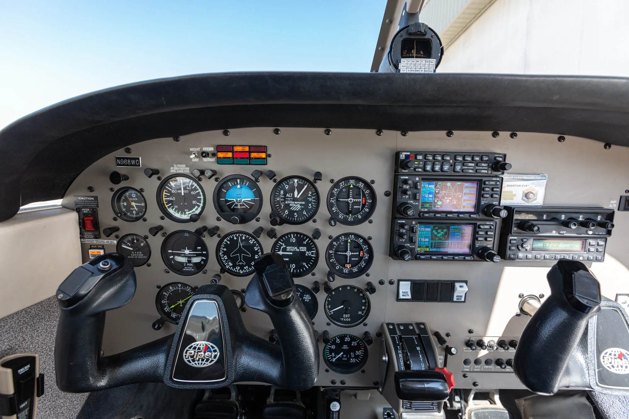The instrument panel and yokes of a Piper Archer III cockpit, showing various gauges and avionics.