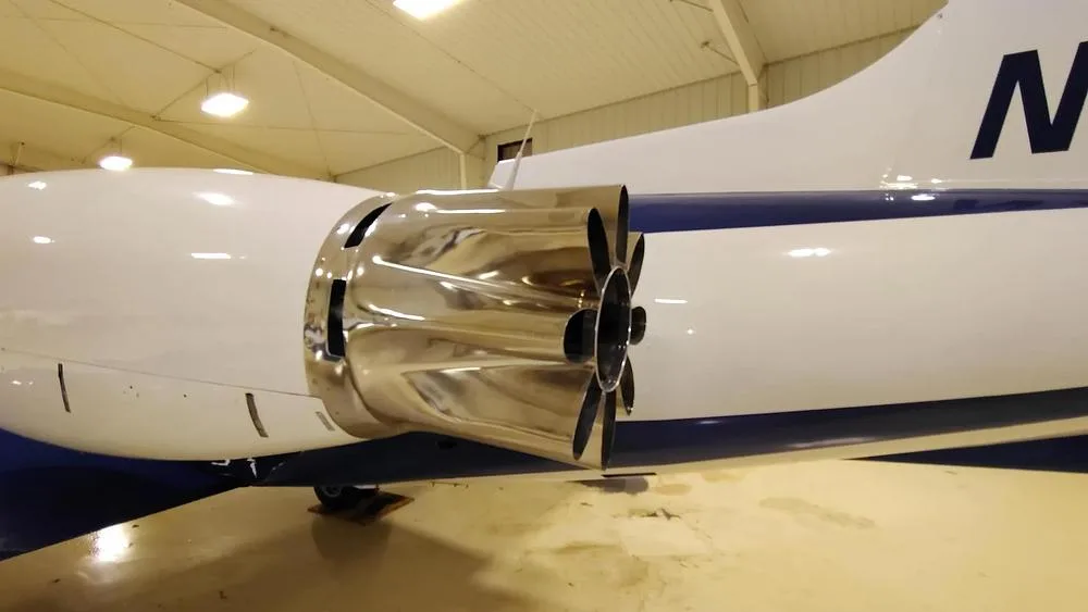 A close-up view of the polished chrome engine exhaust of a Learjet 35A.