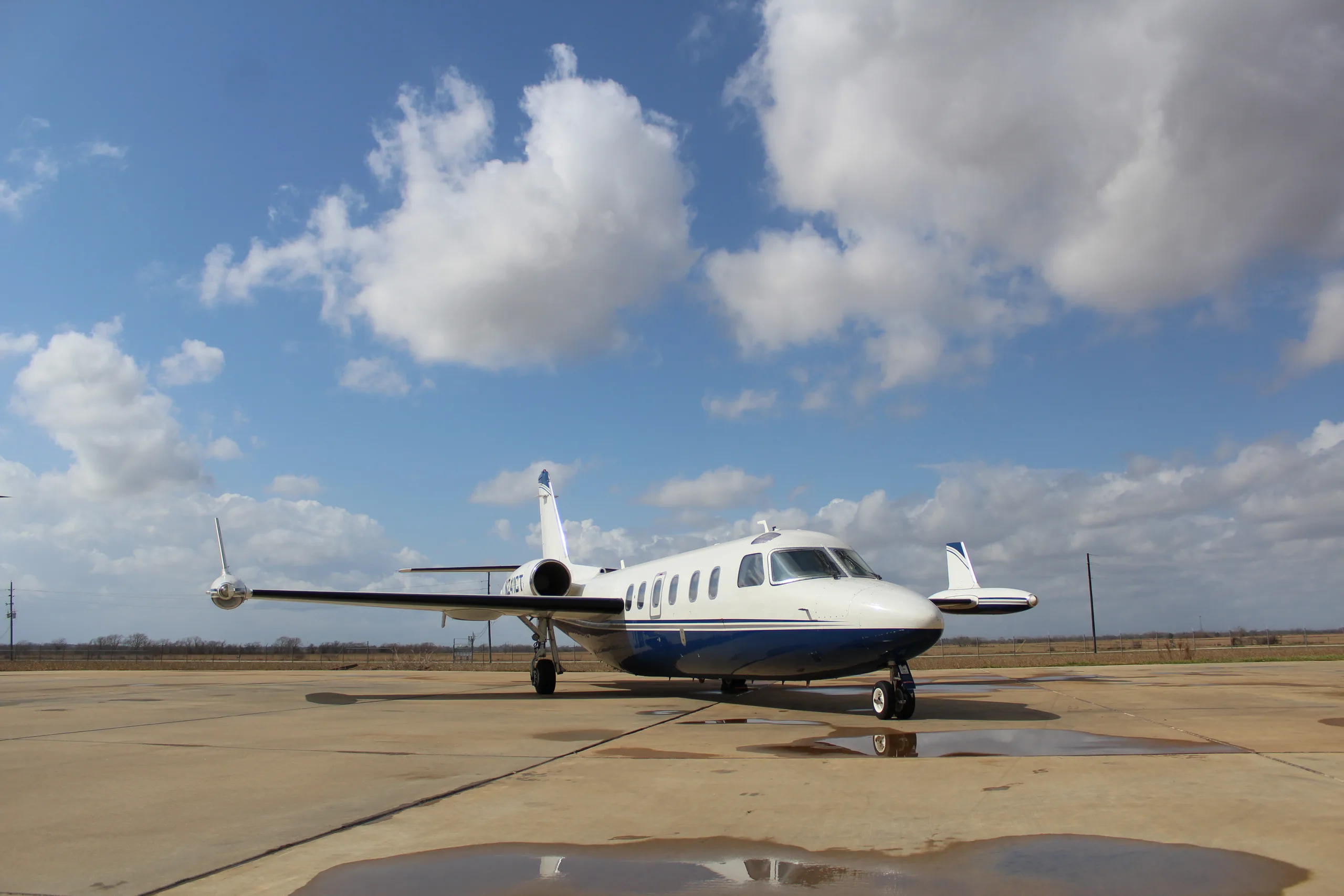 A Westwind Astra SPX aircraft with registration N241CT parked on the tarmac under a cloudy sky.