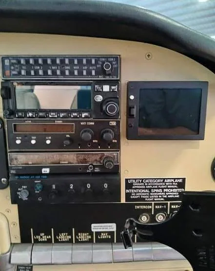 A close-up view of the avionics stack and a small display screen in an aircraft cockpit.