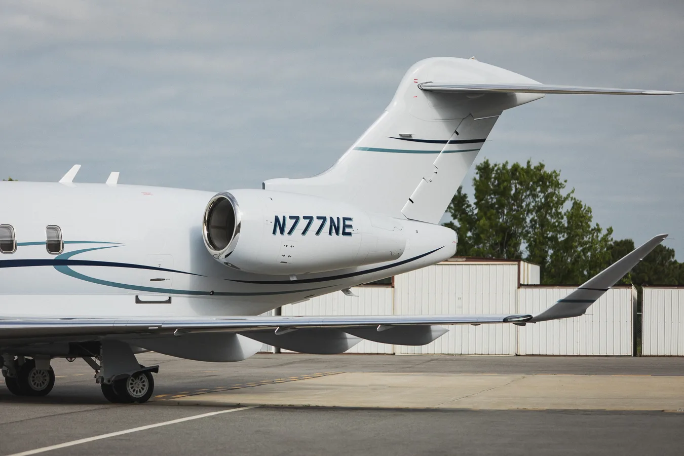 Tail section of N777NE Challenger showing engine and registration.