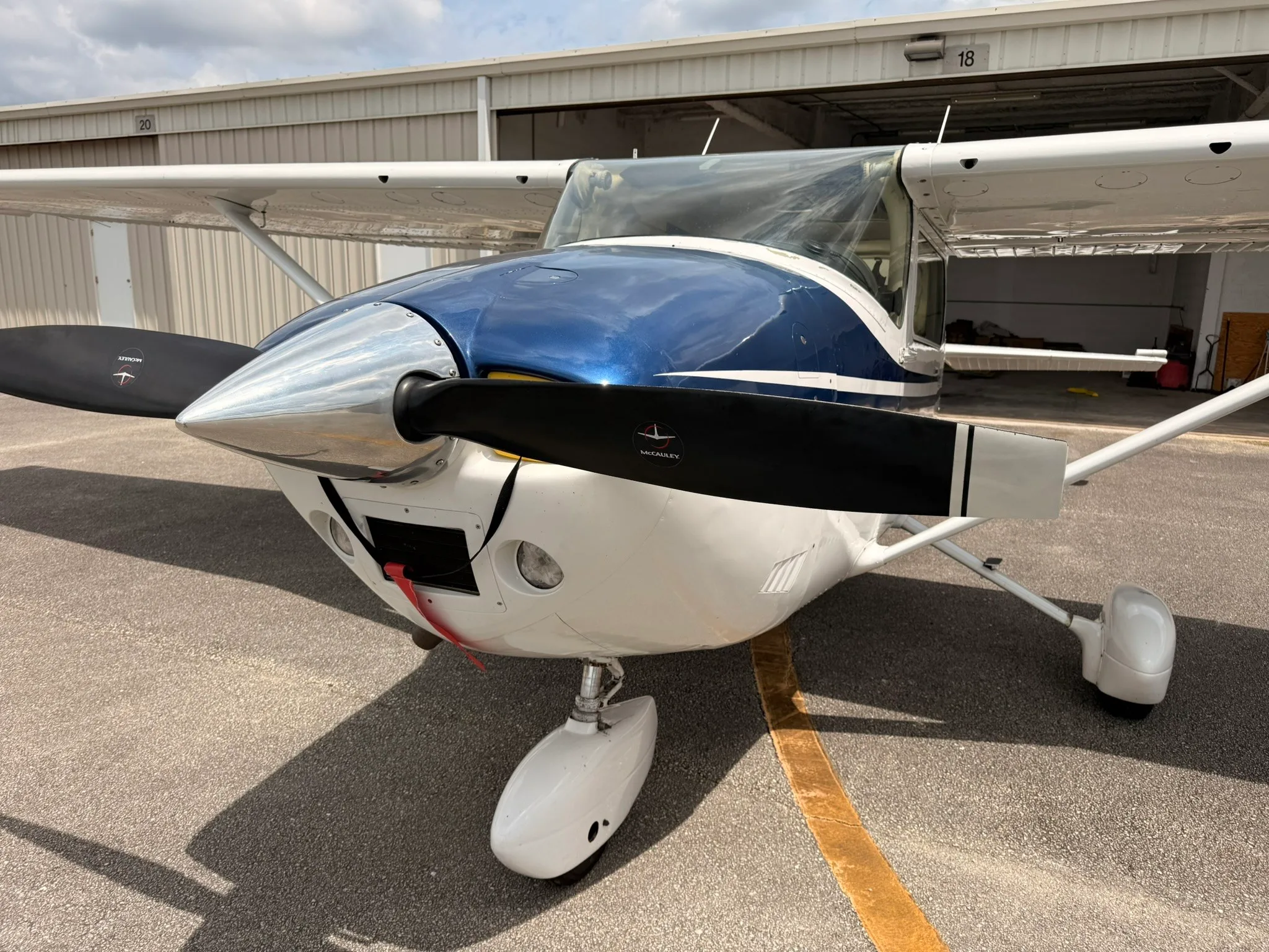 A close-up front view of the propeller and nose of the Cessna Skylane N567SD, showing the McCauley propeller.