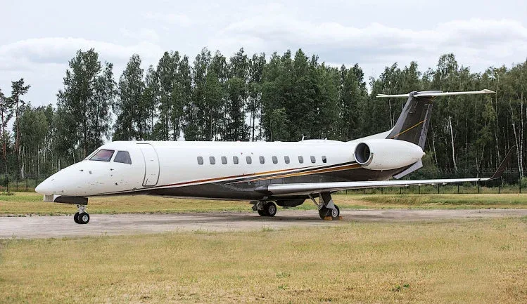 A rendering of a white Bombardier Global Express business jet against a black background.