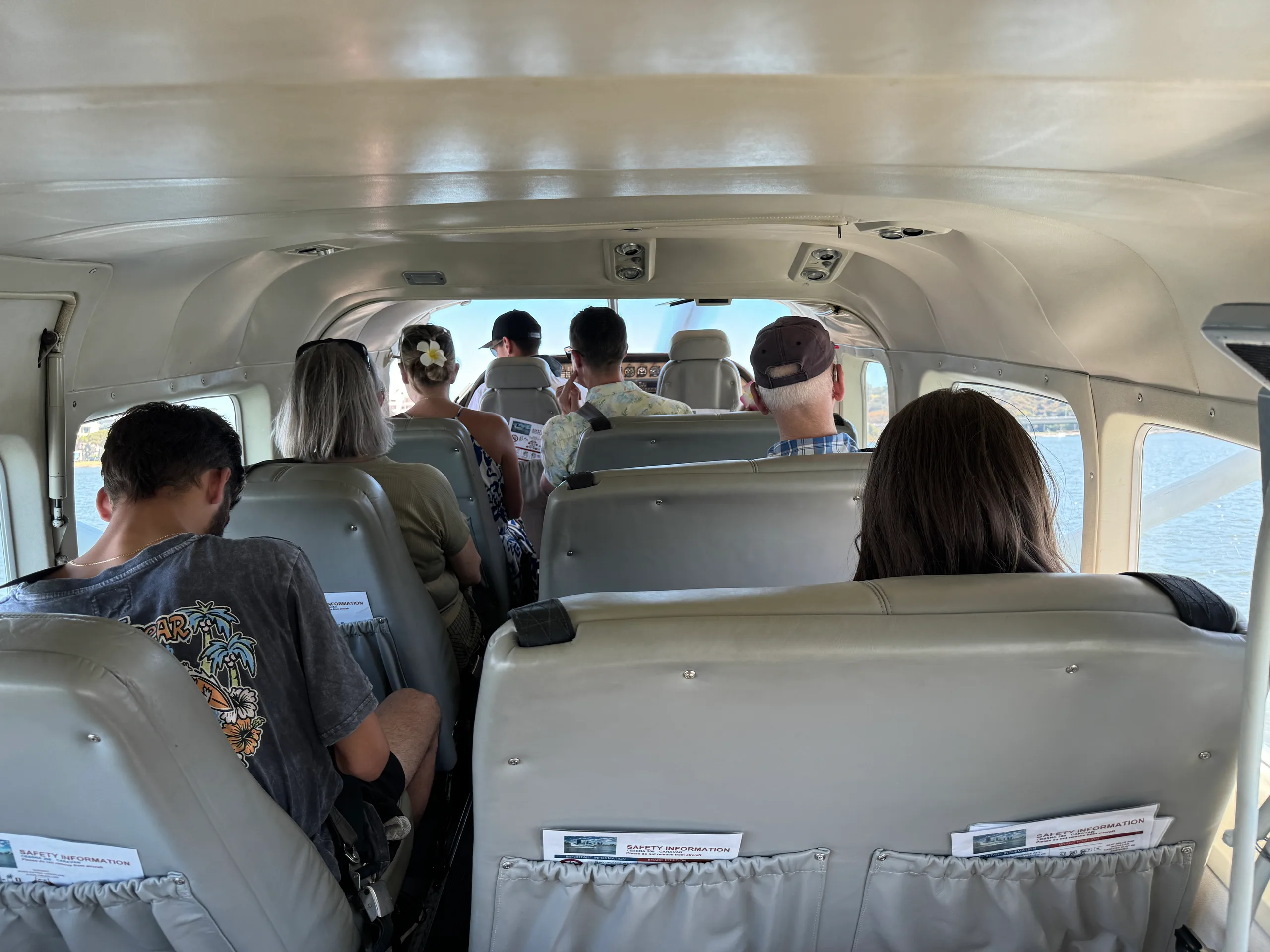 View of the aircraft cabin with passengers seated.